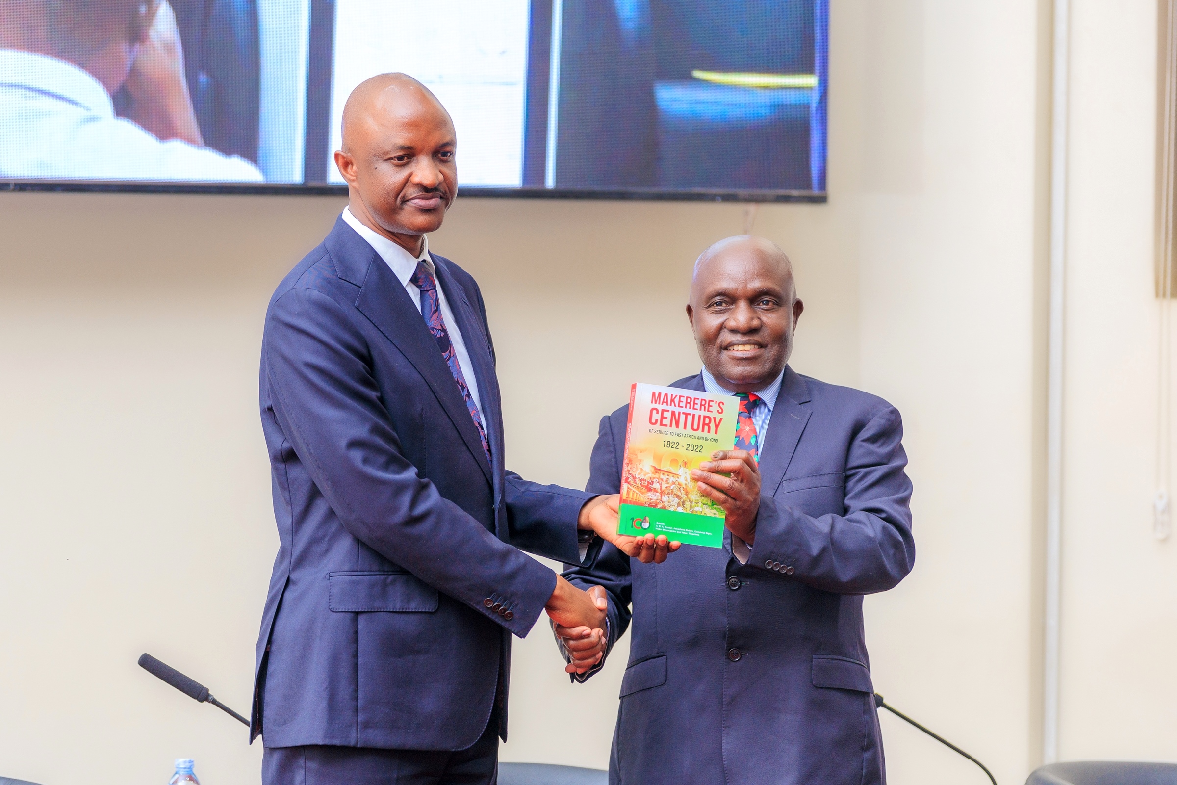 The Chancellor-Hon. Dr. Crispus Kiyonga presents Makerere's Century Publication to Dr. Ramathan Ggoobi on 9th April 2026. Public lecture and high-level dialogue on health financing organised by Makerere University School of Public Health (MakSPH) in collaboration with the Ministry of Health and the Ministry of Finance, Planning, and Economic Development, Keynote: Dr. Ramathan Ggoobi, PSST, Theme “Investing in Health for Uganda’s Future: Delivering Vision 2040 through Smart and Sustainable Health Financing”, 9th April 2026, MakSPH Auditorium, Main Campus, Kampala Uganda, East Africa.