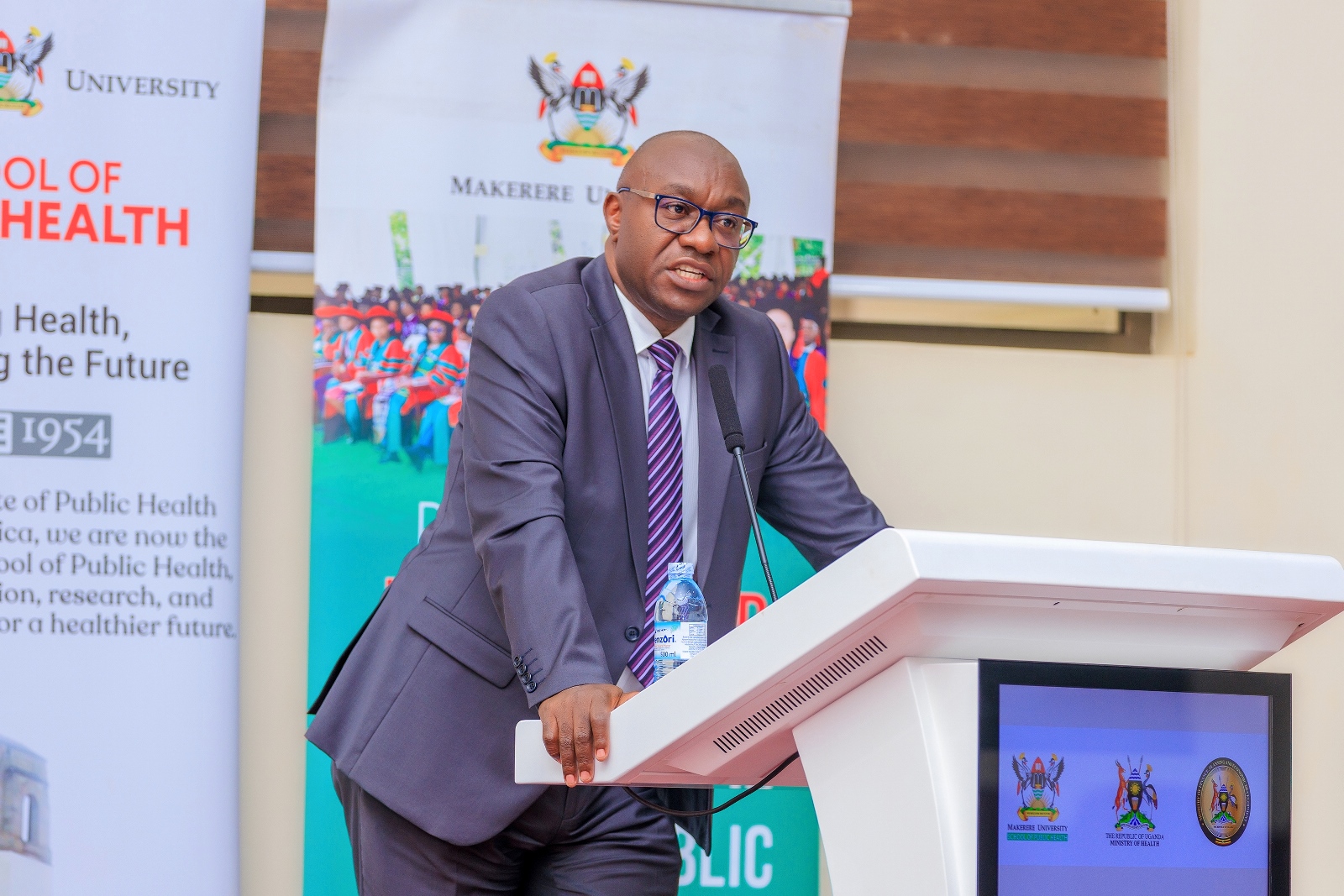 John Kauta, the Commissioner in charge of Health Information, Statistics, Monitoring, and Evaluation gives MoH reflections at the public lecture. Public lecture and high-level dialogue on health financing organised by Makerere University School of Public Health (MakSPH) in collaboration with the Ministry of Health and the Ministry of Finance, Planning, and Economic Development, Keynote: Dr. Ramathan Ggoobi, PSST, Theme “Investing in Health for Uganda’s Future: Delivering Vision 2040 through Smart and Sustainable Health Financing”, 9th April 2026, MakSPH Auditorium, Main Campus, Kampala Uganda, East Africa.