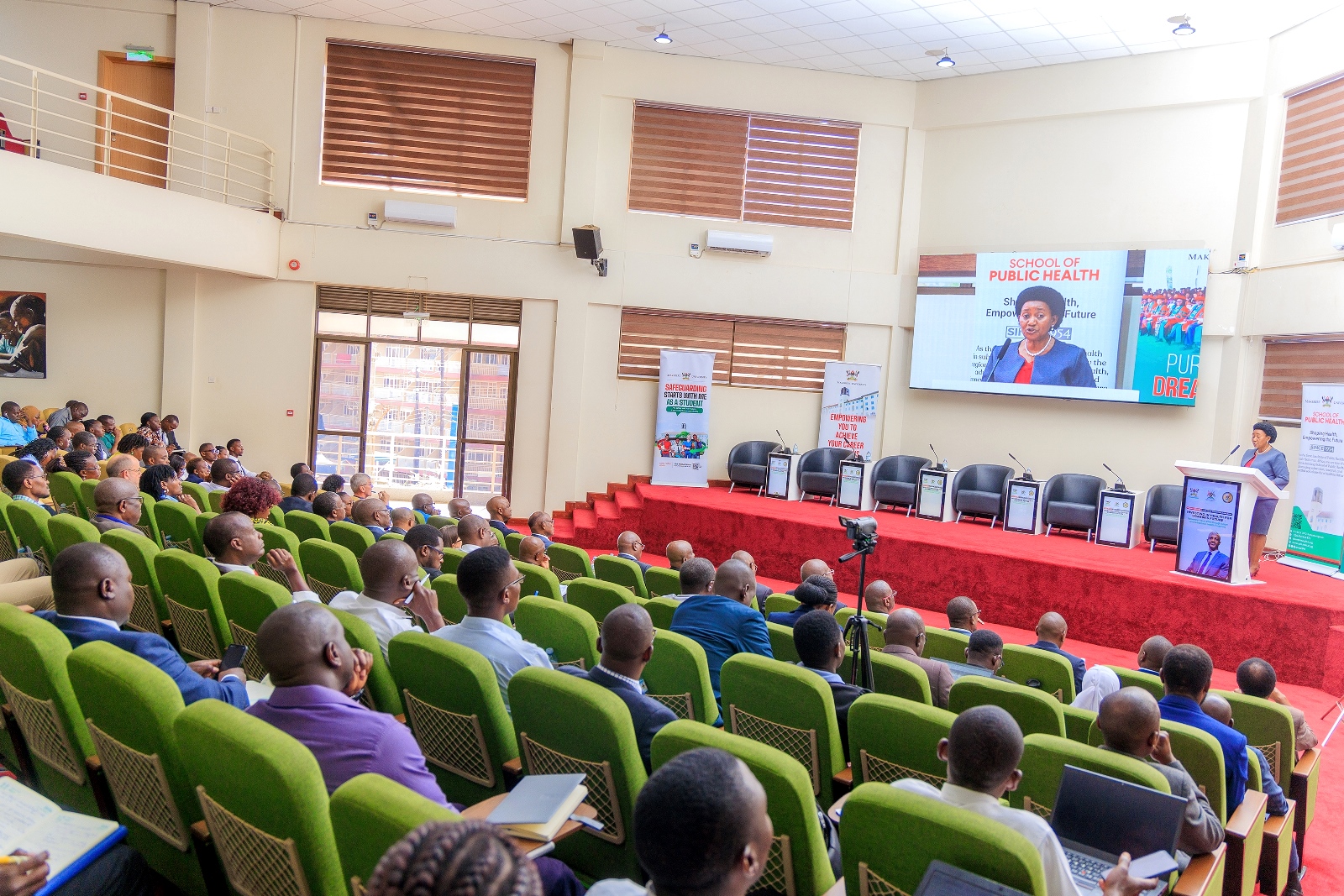 Ms. Jane Kyarisiima Mwesiga, Deputy Head of Public Service (Service Delivery), Office of the Prime Minister, delivers her opening remarks on public health financing in Uganda, emphasizing government commitment to improved service delivery, governance, and increased staffing. Public lecture and high-level dialogue on health financing organised by Makerere University School of Public Health (MakSPH) in collaboration with the Ministry of Health and the Ministry of Finance, Planning, and Economic Development, Keynote: Dr. Ramathan Ggoobi, PSST, Theme “Investing in Health for Uganda’s Future: Delivering Vision 2040 through Smart and Sustainable Health Financing”, 9th April 2026, MakSPH Auditorium, Main Campus, Kampala Uganda, East Africa.