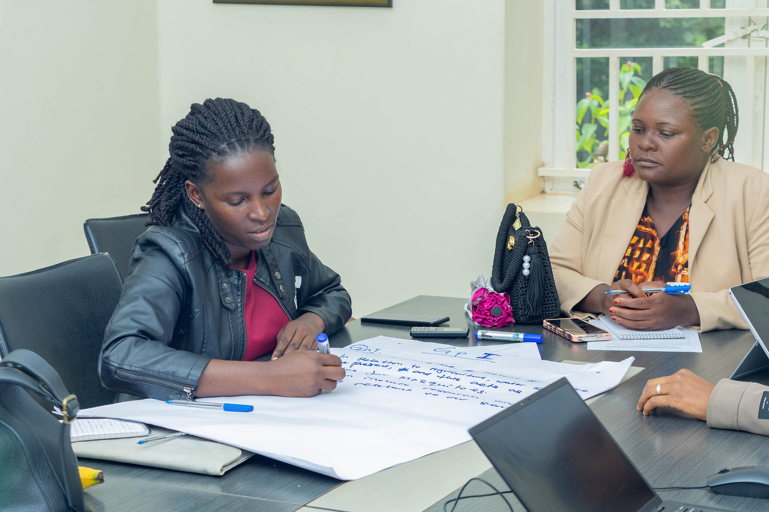Ms. Doreen Nabwire Wamboka, In-charge at Namayumba Epicentre Health Centre III in Wakiso District, engages in a co-creation session as a fellow participant looks on during the stakeholder workshop in Kololo on April 15, 2026, underscoring the need for collaborative approaches to design interventions to tackle malaria. Stakeholders’ workshop on the social determinants of malaria led by Assoc. Prof. David Musoke of Makerere University and Dr. Kevin Deane of The Open University presented ongoing and previous findings, April 15, 2026, at MakSPH’s Resilient Africa Network, Plot 30, Upper Kololo Terrace, Kampala Uganda, East Africa.