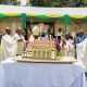 H.E. Maj. (Rtd) Jessica Alupo and His Grace Paul Ssemogerere flanked by Prof. Barnabas Nawangwe, Rev. Fr. Josephat Ddungu, clergy and other officials cuts cake at the thanksgiving Mass on 12th April 2026. Marking 85 years of St. Augustine Chapel under the theme, “Our hearts are restless until they rest in you, O Lord,” thanksgiving Mass led by His Grace, Paul Ssemogerere, Archbishop of the Roman Catholic Archdiocese of Kampala, and Chief Guest as Vice President H.E. Maj. (Rtd)  Jessica Alupo, April 12, 2026, Freedom Square, Makerere University, Kampala Uganda, East Africa.