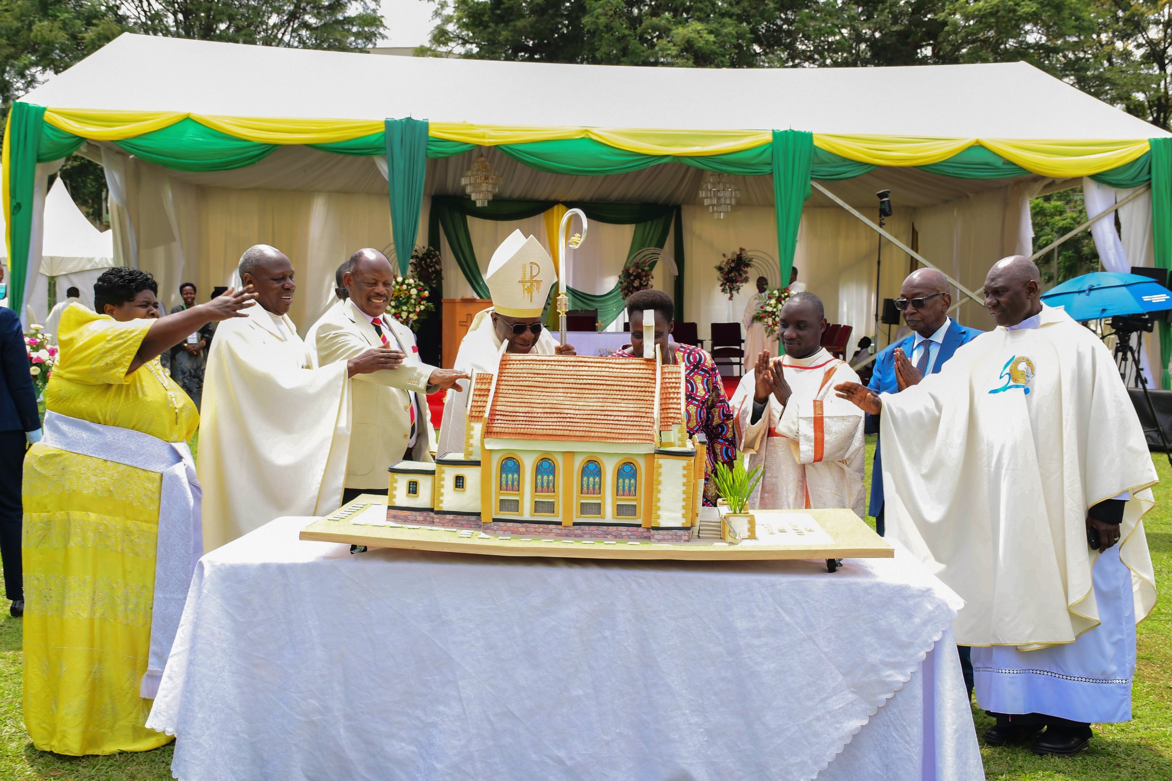 H.E. Maj. (Rtd) Jessica Alupo and His Grace Paul Ssemogerere flanked by Prof. Barnabas Nawangwe, Rev. Fr. Josephat Ddungu, clergy and other officials cuts cake at the thanksgiving Mass on 12th April 2026. Marking 85 years of St. Augustine Chapel under the theme, “Our hearts are restless until they rest in you, O Lord,” thanksgiving Mass led by His Grace, Paul Ssemogerere, Archbishop of the Roman Catholic Archdiocese of Kampala, and Chief Guest as Vice President H.E. Maj. (Rtd)  Jessica Alupo, April 12, 2026, Freedom Square, Makerere University, Kampala Uganda, East Africa.