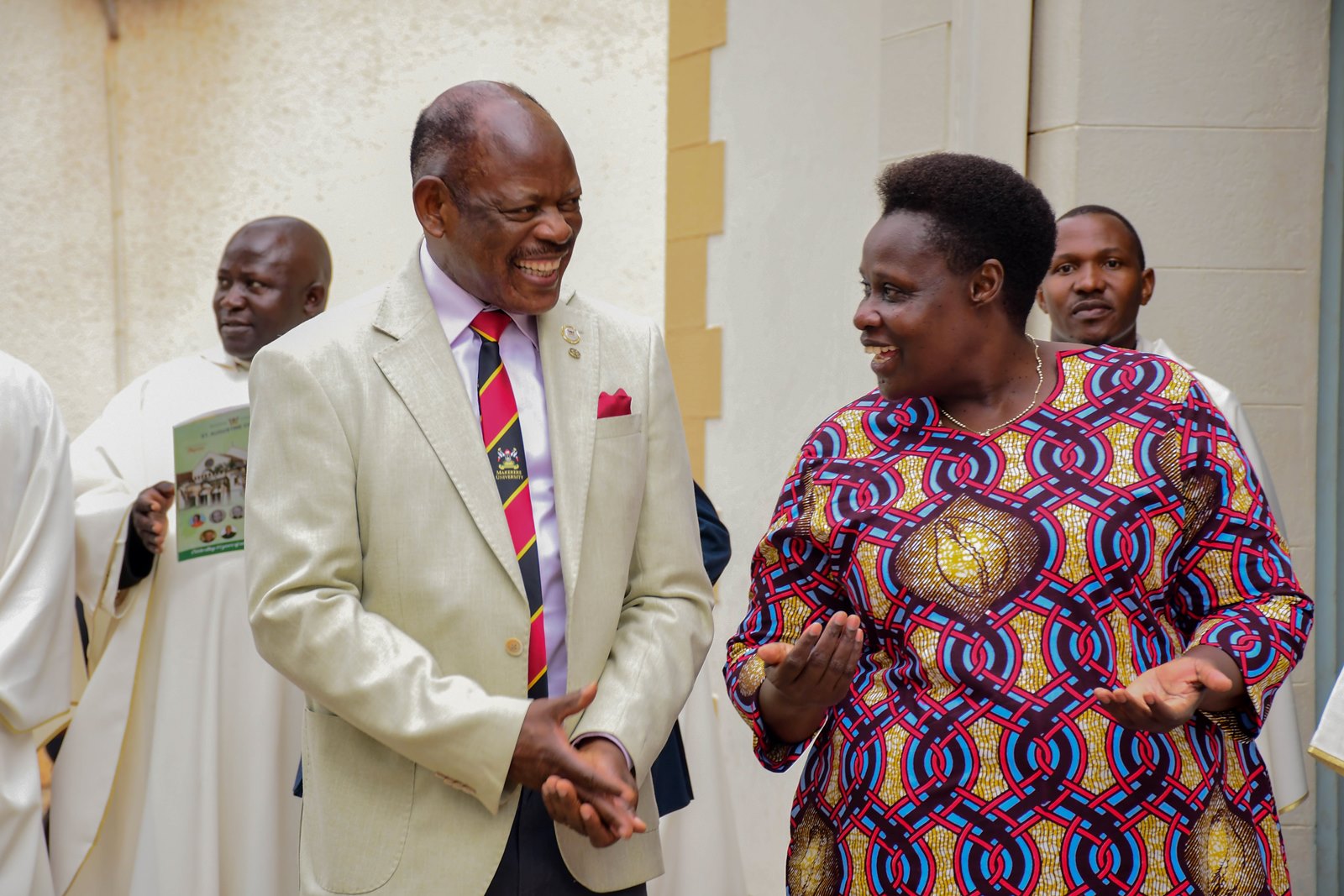 H.E. Maj. (Rtd) Jessica Alupo (R) and Prof. Barnabas Nawangwe share a light moment at St. Augustine Chapel. Marking 85 years of St. Augustine Chapel under the theme, “Our hearts are restless until they rest in you, O Lord,” thanksgiving Mass led by His Grace, Paul Ssemogerere, Archbishop of the Roman Catholic Archdiocese of Kampala, and Chief Guest as Vice President H.E. Maj. (Rtd)  Jessica Alupo, April 12, 2026, Freedom Square, Makerere University, Kampala Uganda, East Africa.
