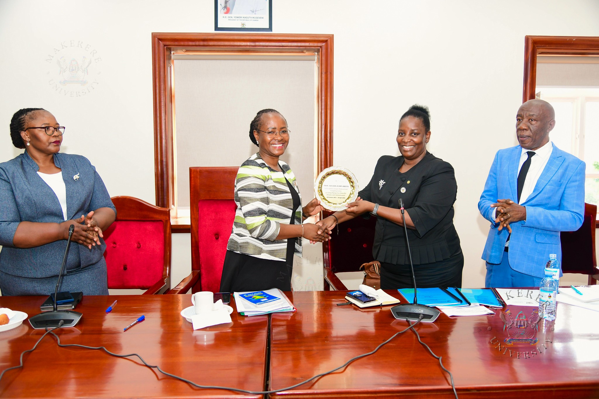 Prof. Helen Nambalirwa Nkabala (2nd R) receives a plaque on behalf Prof. Winston Tumps Ireeta from Prof. Sarah Ssali (2nd L) as Prof. Henry Alinaitwe (R) and CPA Agnes Khwaka (L) witness on 4th May 2026. Handover of Office of Deputy Vice Chancellor (Finance and Administration)-DVCFA from Prof. Winston Tumps Ireeta to Prof. Henry Alinaitwe, 4th May 2026, Council Room, Main Building, Makerere University, Kampala Uganda, East Africa.