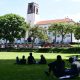 Student discussion groups converge in tree shades on the edges of the Freedom Square overlooked by the Main Building. Makerere University, Kampala Uganda, East Africa.