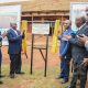 Hon. Peter Ogwang unveils the foundation stone for the AFCON 2027 Training Grounds at Makerere University on behalf of Hon. Janet Kataaha Museveni as Hon. Dr. Crispus Kiyonga (2nd L), Prof. Barnabas Nawangwe (L) and other officials witness on 19th February 2027. Groundbreaking ceremony for the AFCON 2027 training facilities at Makerere University and commissioning of six construction sites in Hoima, Masindi, Kyambogo University, Lira University, and Gulu University, 19th February 2026, Main Sports Grounds, Kampala Uganda, East Africa.