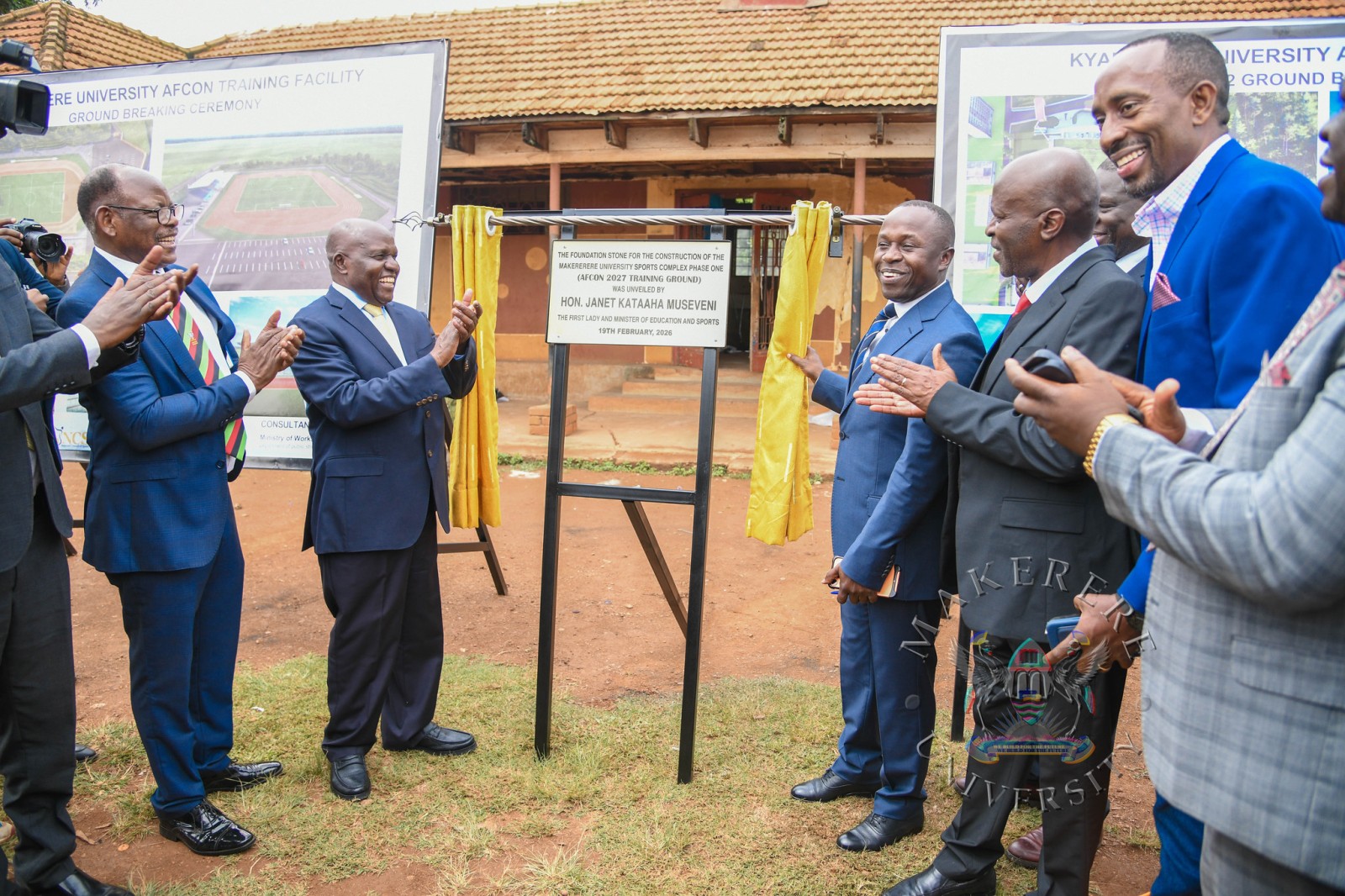 Hon. Peter Ogwang unveils the foundation stone for the AFCON 2027 Training Grounds at Makerere University on behalf of Hon. Janet Kataaha Museveni as Hon. Dr. Crispus Kiyonga (2nd L), Prof. Barnabas Nawangwe (L) and other officials witness on 19th February 2027. Groundbreaking ceremony for the AFCON 2027 training facilities at Makerere University and commissioning of six construction sites in Hoima, Masindi, Kyambogo University, Lira University, and Gulu University, 19th February 2026, Main Sports Grounds, Kampala Uganda, East Africa.