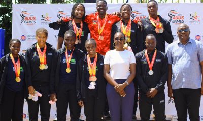 The Dean of Students-Dr. Winifred Kabumbuli (3rd R) and Principal Sports Tutor-Mr. Brian Miiro (R) at the podium with Mak Sharks Team Members that claimed both best overall trophies for the Men and Ladies categories at the AUUS Games in December 2025. Making Waves: The Rise of the Mak Sharks and Makerere University's Aquatic Legacy, Swimming, Kampala Uganda, East Africa.