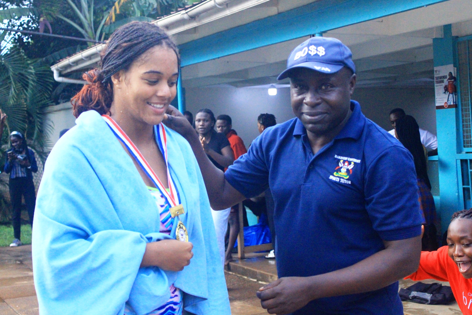 Sports Tutor-Mr. Mugera Joseph (Right) congratulates Anna Chloe Sophie Obiajunwa on her outstanding performance. The Inter-Hall Swimming Championships, 17th April 2026, Makerere University Pool, Kampala Uganda, East Africa. Photos: Patrick Kawaii Instagram/WabwireJr