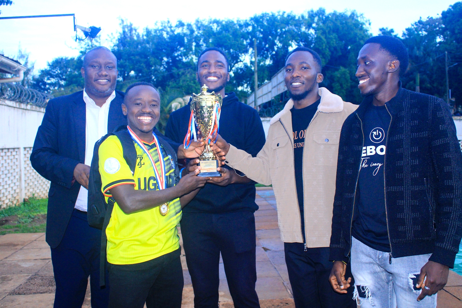 Mr. Brian Miiro (Left) with University Hall Swimmers that emerged Overall Winners of the Boys' category. The Inter-Hall Swimming Championships, 17th April 2026, Makerere University Pool, Kampala Uganda, East Africa. Photos: Patrick Kawaii Instagram/WabwireJr