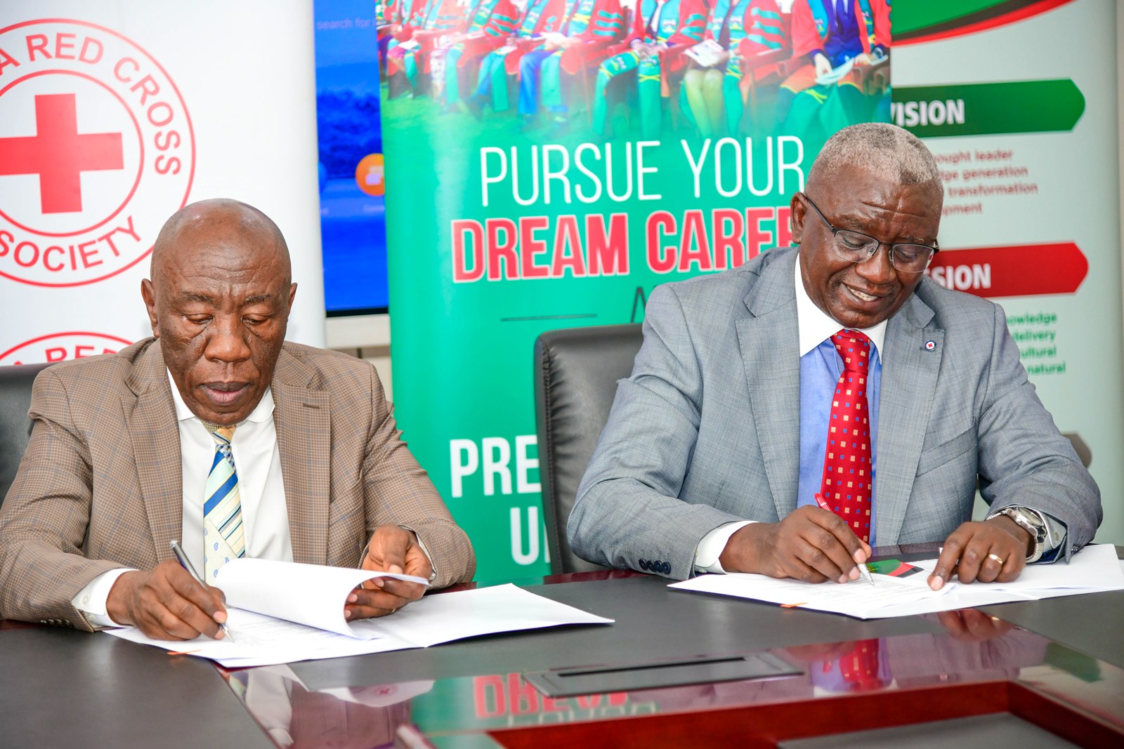 Prof. Alinaitwe and Mr. Kwesiga signing the MoU. Makerere University and Uganda Red Cross Society (URCS) sign Memorandum of Understanding (MoU) aimed at strengthening collaboration in research, training, innovation, and humanitarian service delivery, 19th May 2026, Main Building, Kampala, East Africa.
