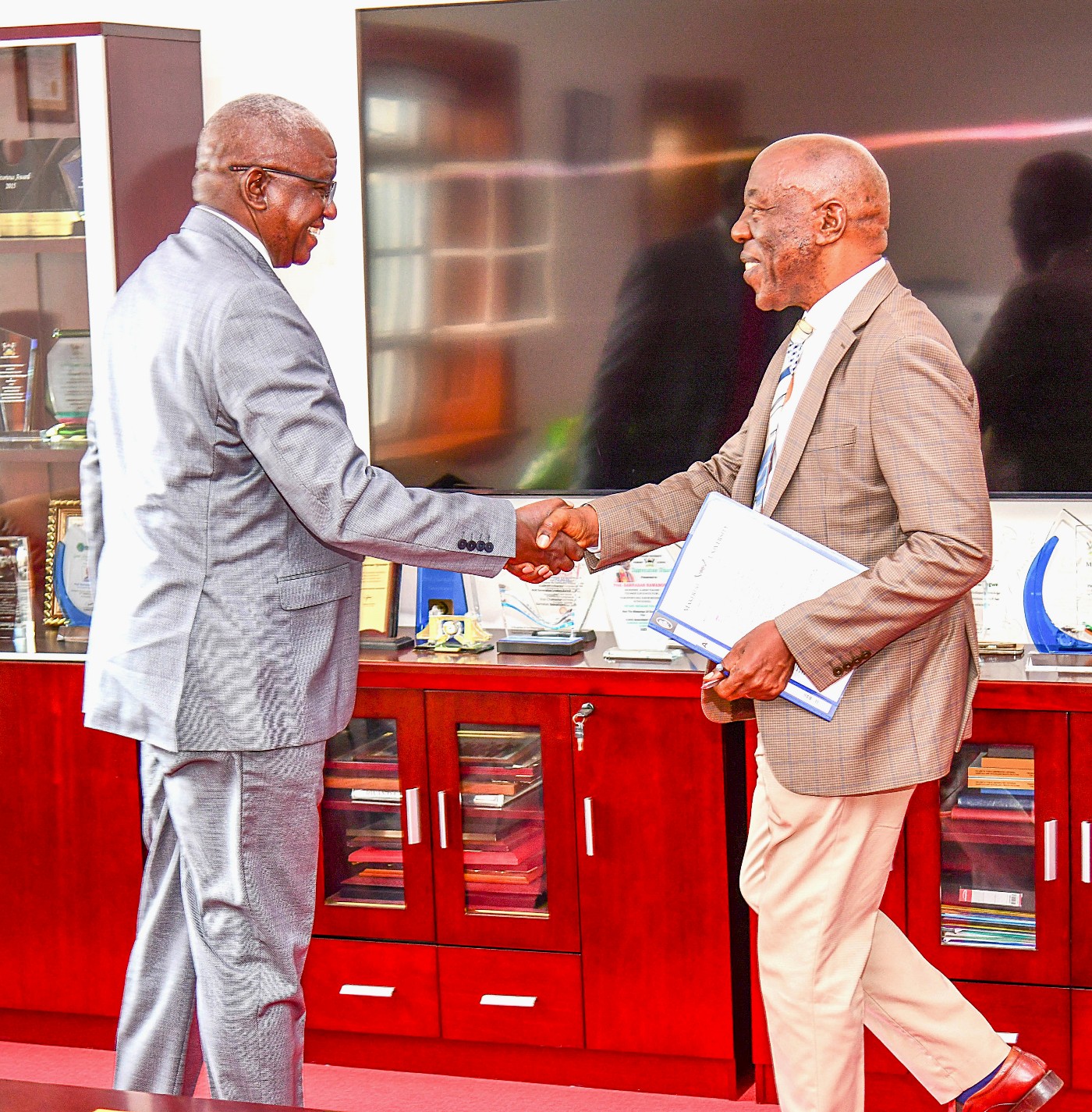 Makerere University DVCFA, Prof. Henry Alinaitwe welcoming URCS Secretary General, Mr. Robert Kwesiga to the MoU signing ceremony held on 19th May 2026. Makerere University and Uganda Red Cross Society (URCS) sign Memorandum of Understanding (MoU) aimed at strengthening collaboration in research, training, innovation, and humanitarian service delivery, 19th May 2026, Main Building, Kampala, East Africa.