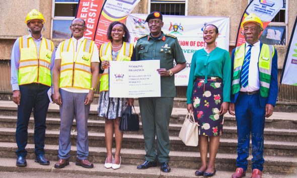 Lt. Gen. James Mugira (3rd R) and Guild President H.E. Kadondi Gracious (3rd L) display a copy of the CCE Complex Working Drawings at the site handover on 26th June 2026 as L-R: Eng. Brian Buhanda, Prof. Barnabas Nawangwe, Dr. Winifred Kabumbuli and Prof. Henry Alinaitwe witness. Vice Chancellor, Prof. Barnabas Nawangwe hands over CCE (Complex) Hall of Residence Site to National Enterprise Corporation (NEC) Managing Director and CEO, Lt. Gen. James Mugira for renovation and overhaul works, Friday, 26th June 2026, Makerere University, Kampala Uganda, East Africa.