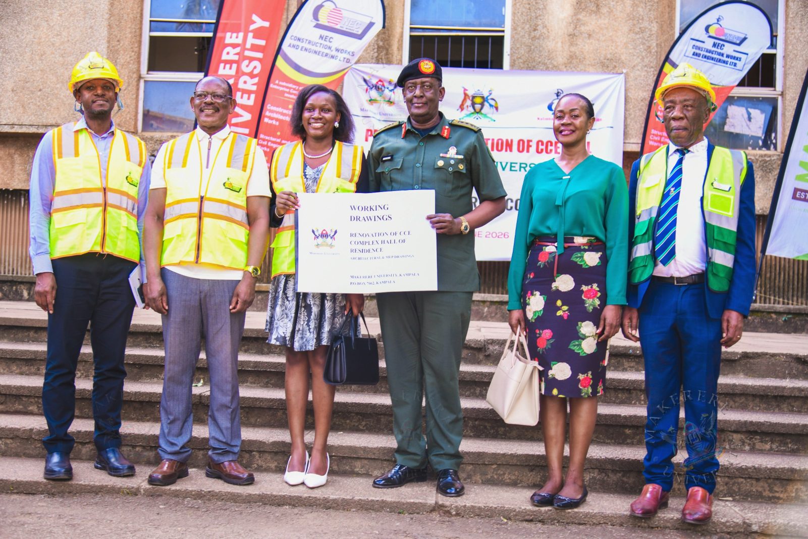 Lt. Gen. James Mugira (3rd R) and Guild President H.E. Kadondi Gracious (3rd L) display a copy of the CCE Complex Working Drawings at the site handover on 26th June 2026 as L-R: Eng. Brian Buhanda, Prof. Barnabas Nawangwe, Dr. Winifred Kabumbuli and Prof. Henry Alinaitwe witness. Vice Chancellor, Prof. Barnabas Nawangwe hands over CCE (Complex) Hall of Residence Site to National Enterprise Corporation (NEC) Managing Director and CEO, Lt. Gen. James Mugira for renovation and overhaul works, Friday, 26th June 2026, Makerere University, Kampala Uganda, East Africa.