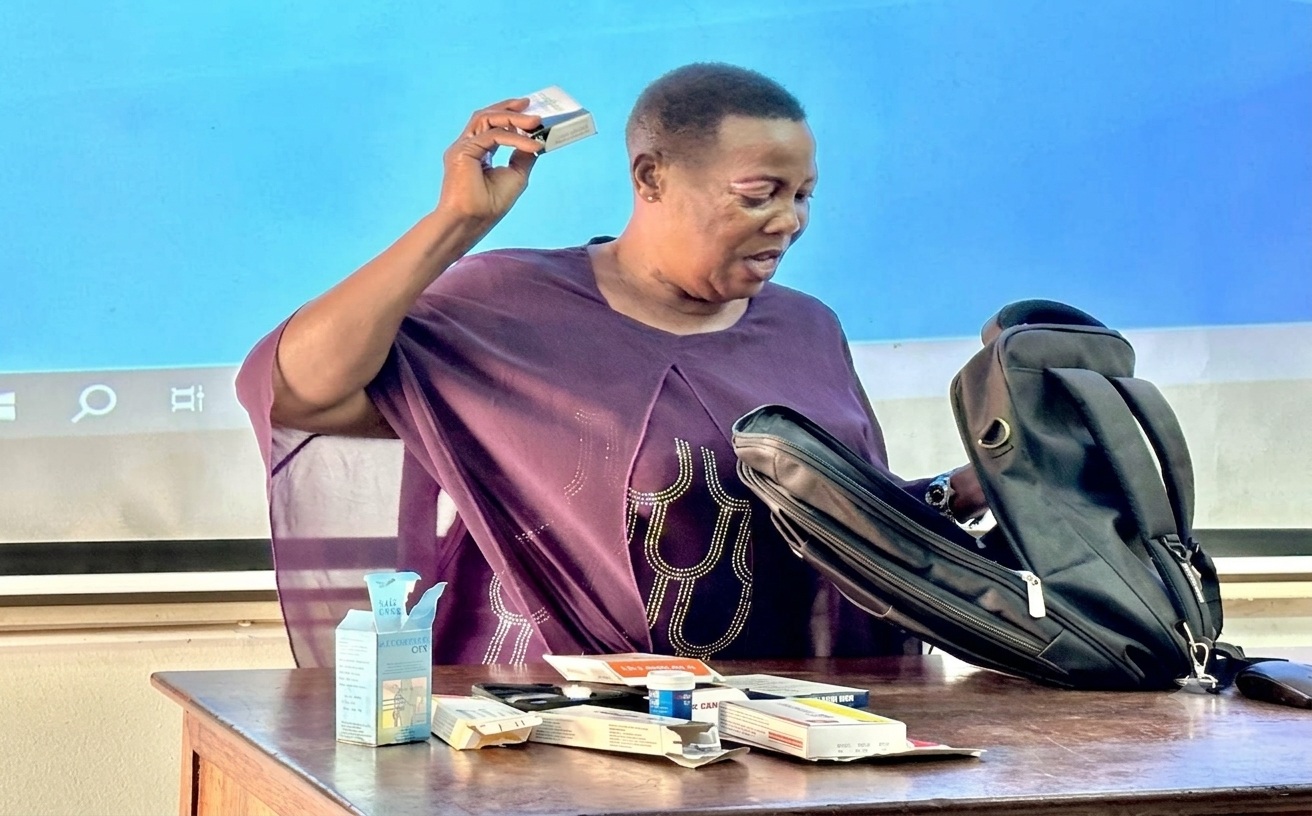 A study participant displays several diabetes medications as she narrates how the psychosocial intervention improved her ability to manage the condition. Physiology Lecture Theatre at the College of Health Sciences, Mulago Hospital Complex, Makerere University, Kampala Uganda, East Africa.