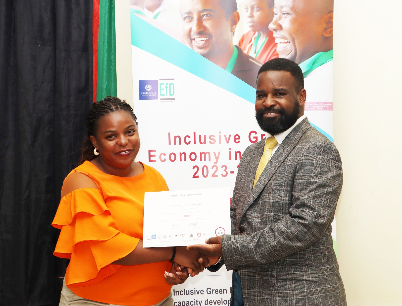 Irene Kemigisha, one of the graduands receives her certificate. Makerere University Environment for Development Initiative (EfD- Mak Centre) graduation of five senior government officials under the 2025 Inclusive Green Economy (IGE) Fellowship Programme, equipping them with advanced knowledge and skills to champion climate-smart agriculture (CSA) and sustainable development in Uganda, June 25, 2026, Makerere University Agricultural Research Institute, Kabanyolo (MUARIK), Wakiso, East Africa.