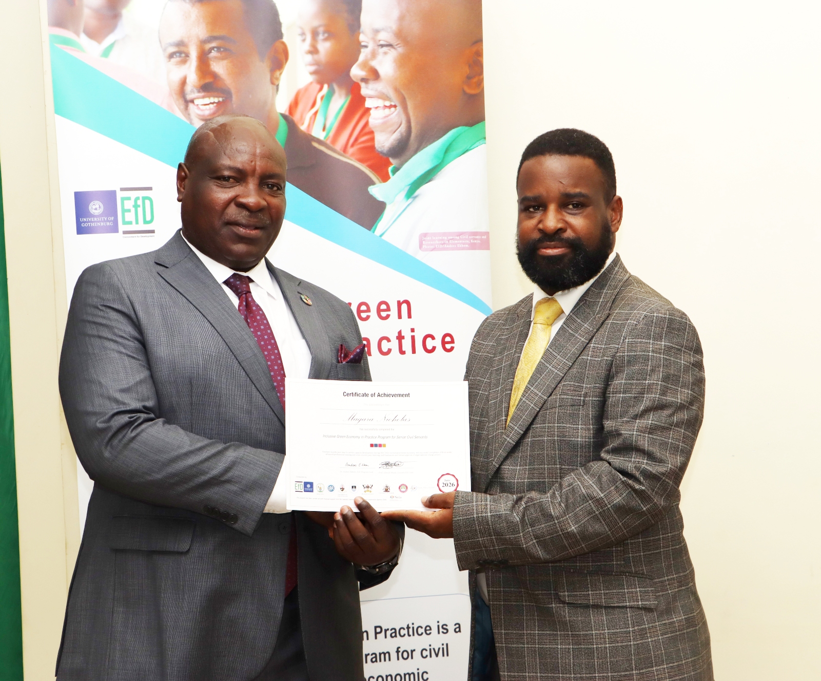 Magara Nicholas poses for a photo with the representative of the VC. Makerere University Environment for Development Initiative (EfD- Mak Centre) graduation of five senior government officials under the 2025 Inclusive Green Economy (IGE) Fellowship Programme, equipping them with advanced knowledge and skills to champion climate-smart agriculture (CSA) and sustainable development in Uganda, June 25, 2026, Makerere University Agricultural Research Institute, Kabanyolo (MUARIK), Wakiso, East Africa.