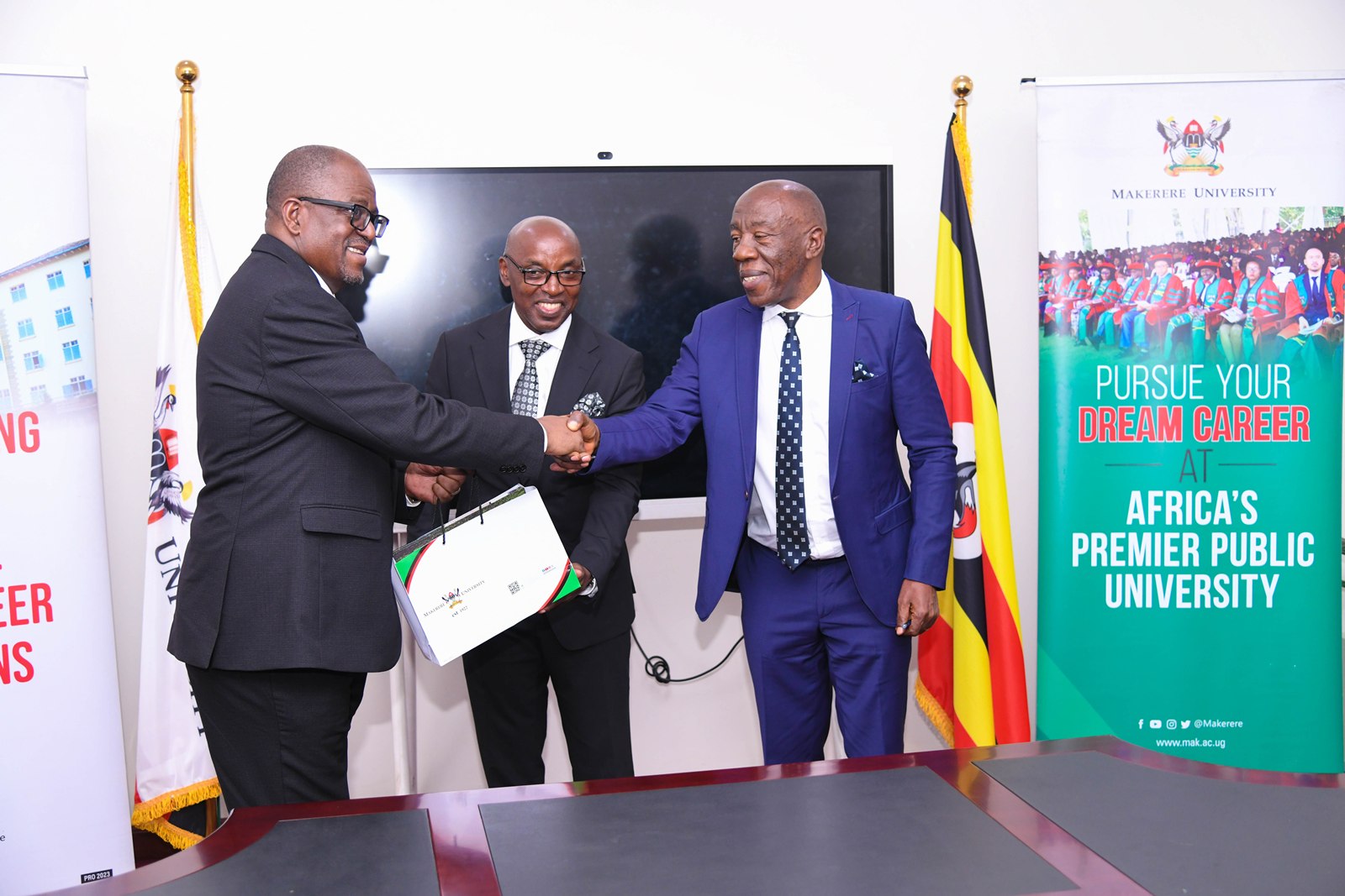 Prof. Henry Alinaitwe hands over Makerere Souvenirs to Hon. Justice Dr. Malila (R) as Hon. Justice Dr. Zeija (C) witnesses. Courtesy Visit of the Chief Justice of the Republic of Zambia, Hon. Justice Dr. Mumba Malila and the Chief Justice of Uganda, Hon. Justice Dr. Flavian Zeija on sidelines of the African Chief Justices' Forum on Alternative Dispute Resolution (ADR) leadership handover ceremony, 16th June 2026, Makerere University, Kampala Uganda.