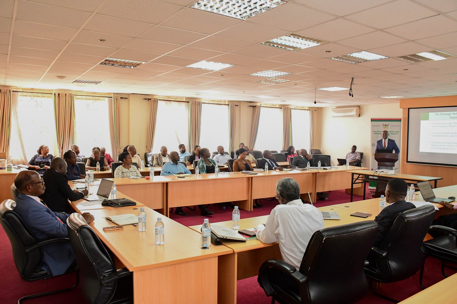 Prof. Bbaale (Standing) makes his remarks. The Vice Chancellor, Prof. Barnabas Nawangwe calls upon members of faculty and researchers at the College of Business and Management Sciences (CoBAMS) to harness the power of graduate training to change Africa’s research trajectory, 15th June 2026, School of Business Conference Room, Makerere University, Kampala Uganda, East Africa.