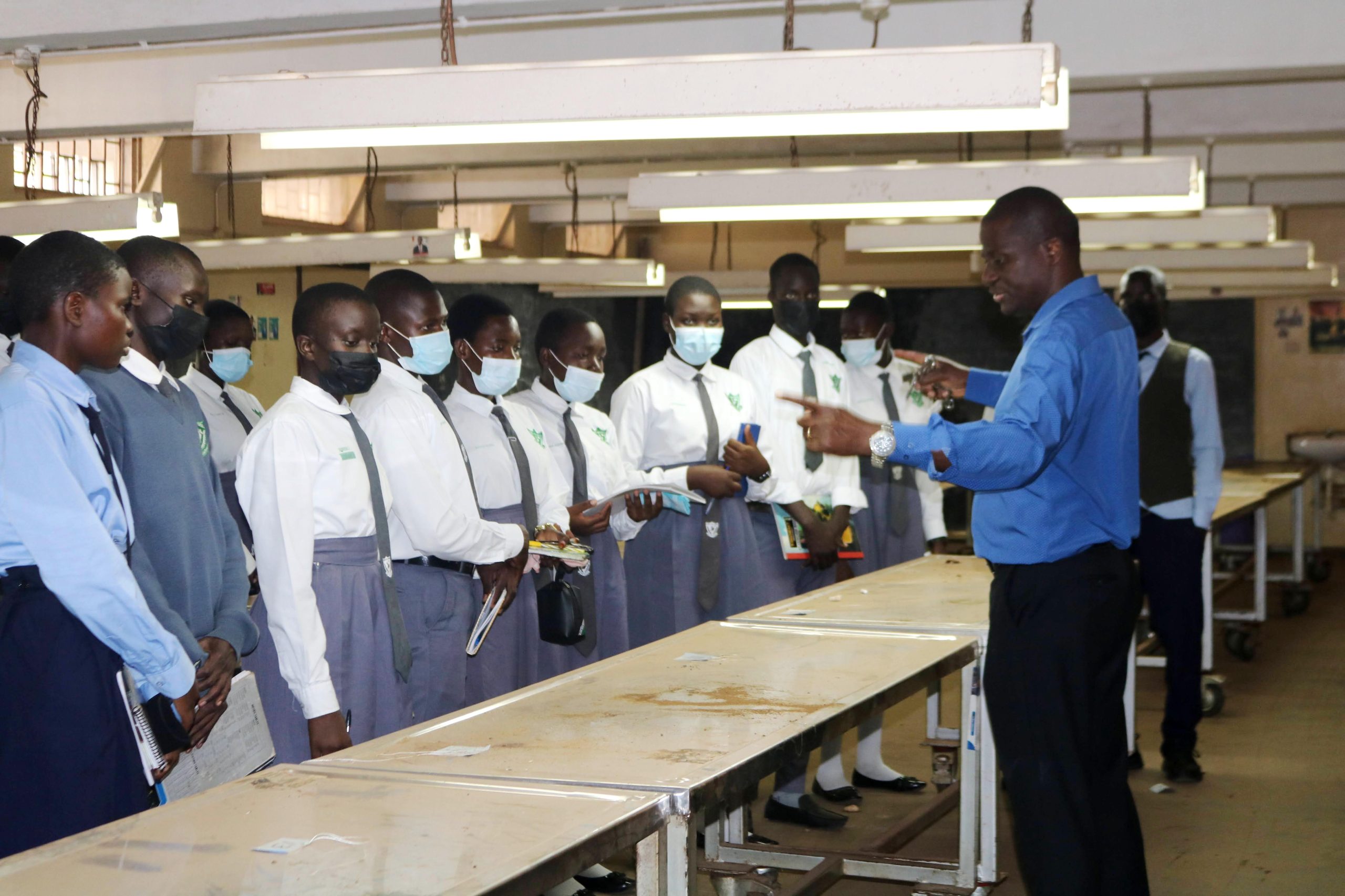 Prof. Erisa Mwaka with students in one of the teaching spaces. Makerere University College of Health Sciences (MakCHS) Career Fair for Ngora High School and Wiggins Secondary School guiding senior six science students on careers in health sciences and introducing them to the wide range of academic programmes offered by the College, 10th July 2026, Mulago Hospital Complex, Kampala Uganda, East Africa.