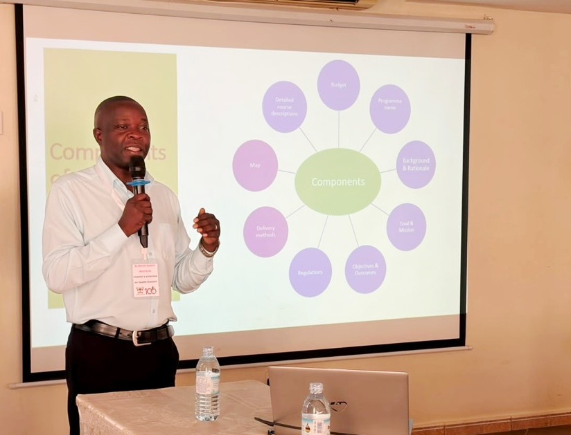Dr. Innocent Besigye presenting the processes for curriculum review on 19 June 2026. Makerere University College of Health Sciences (MakCHS) Quality Assurance (QA) Training in Assessments, Pedagogy and Competence Based Curriculum Held 18–19 June 2026 at Esella Hotel, Waksio, Uganda, East Africa.