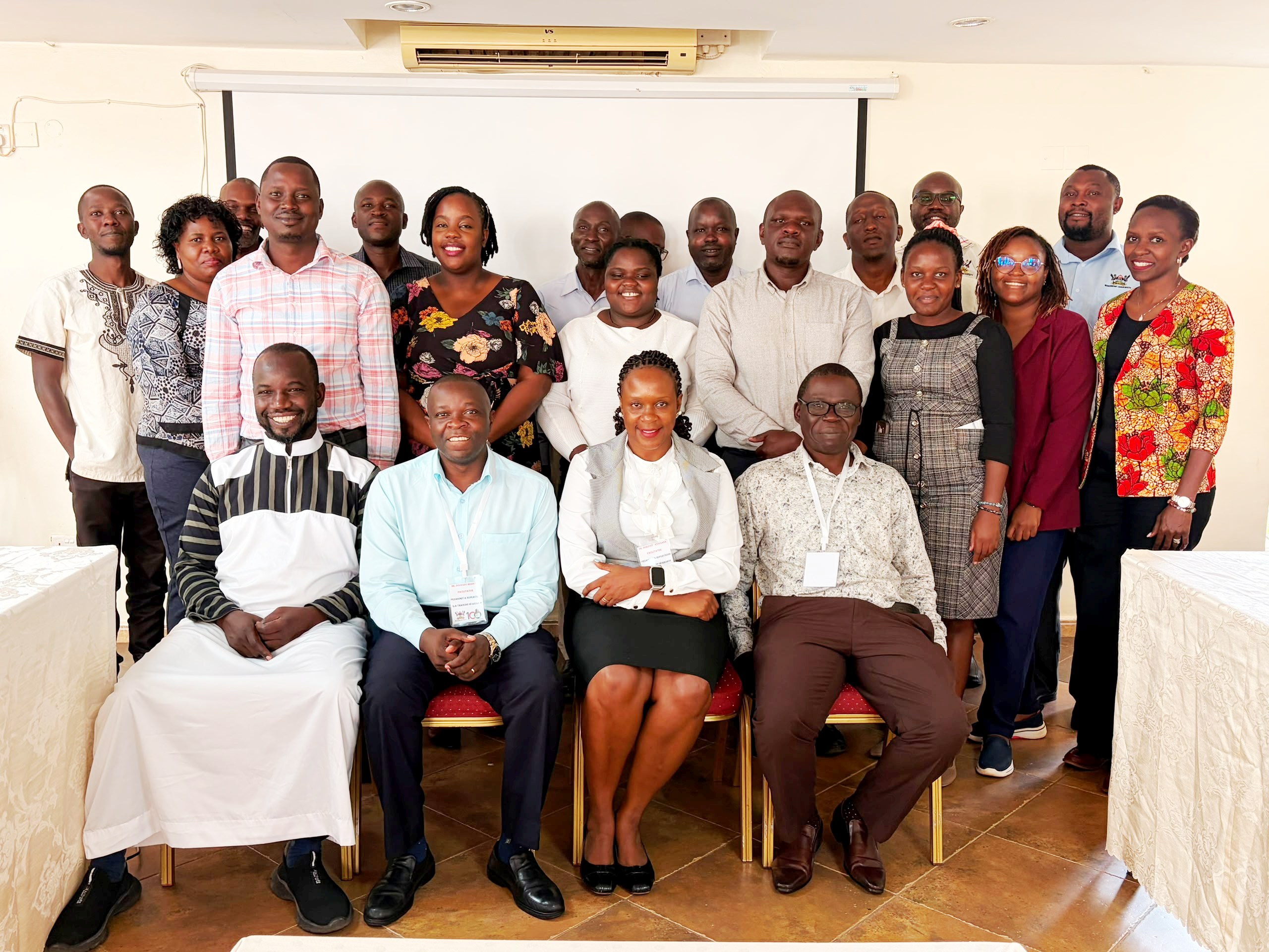 Seated L-R: Dr Kalidi Rajab, Dr. Besigye Innocent, Dr. Dorothy Kyagaba & Dr. Ssenkusu Peter with the participants on 19th June 2026. Makerere University College of Health Sciences (MakCHS) Quality Assurance (QA) Training in Assessments, Pedagogy and Competence Based Curriculum Held 18–19 June 2026 at Esella Hotel, Waksio, Uganda, East Africa.