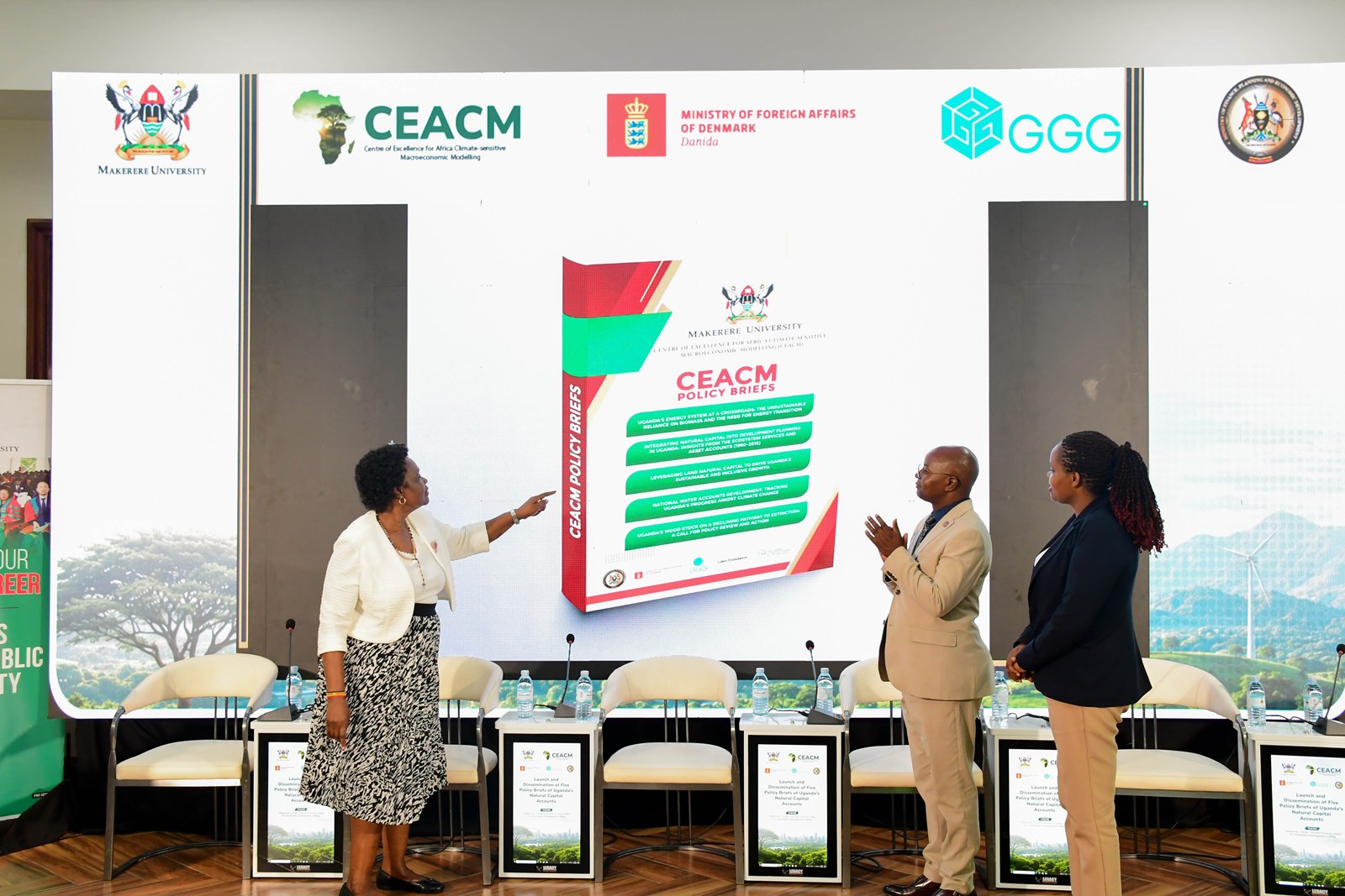 Hon. Beatrice Atim Anywar (Left), Uganda's Minister of State for Environment, unveils the CEACM policy briefs at Makerere University as Prof. Edward Bbaale, CEACM Director, looks on. Launch of Policy Briefs developed by the Centre of Excellence for Africa Climate-Sensitive Macroeconomic Modelling (CEACM), College of Business and Management Sciences (CoBAMS), 15th July 2026, Senior Common Room, Main Building, Makerere University, Kampala Uganda, East Africa.