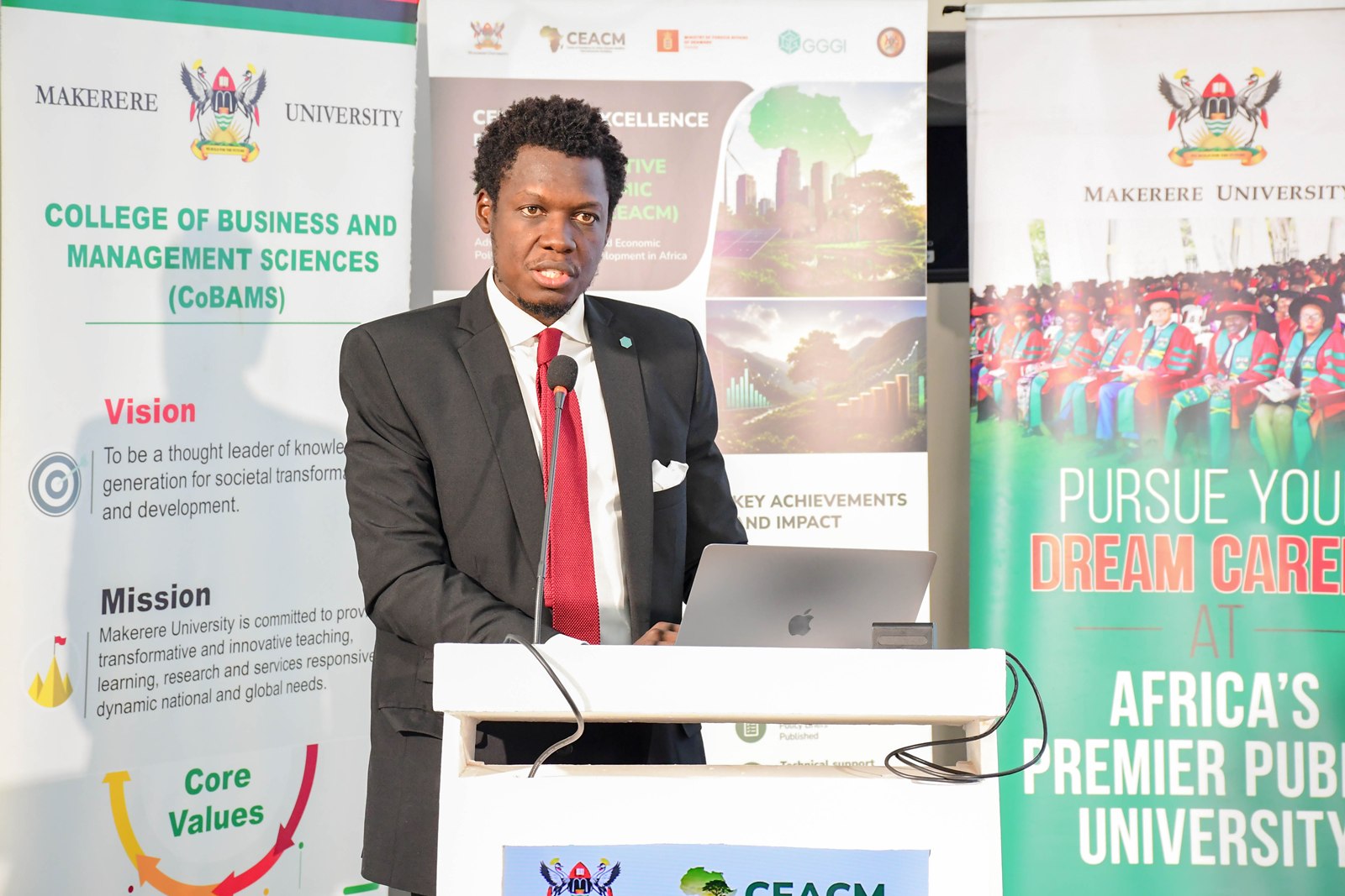 Mr. Arthur Ssebbugga-Kimeze, Climate Finance Manager, representing the GGGI Country Representative, addresses participants. Launch of Policy Briefs developed by the Centre of Excellence for Africa Climate-Sensitive Macroeconomic Modelling (CEACM), College of Business and Management Sciences (CoBAMS), 15th July 2026, Senior Common Room, Main Building, Makerere University, Kampala Uganda, East Africa.