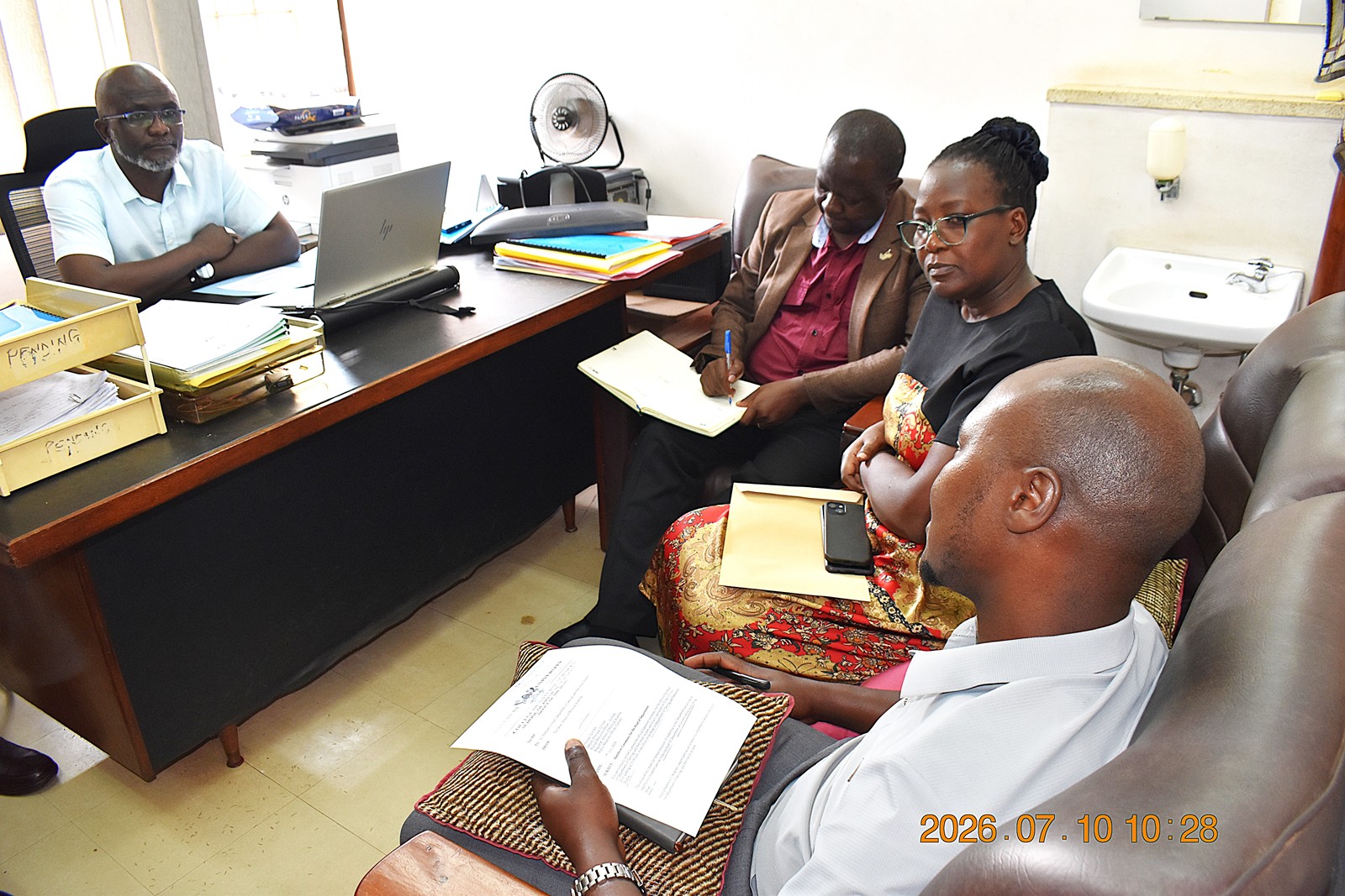 Mr. Moses Gidongo from the Directorate of Internal Audit addressing the team. Handover from Dr Arthur Batte to Dr John Mary Kiberu, appointed Acting Head of the Department of Geology and Petroleum Studies effective 1st July 2026, presided over by the Dean of the School of Physical Sciences, Prof. David Ssevviiri on 10th July 2026, College of Natural Sciences (CoNAS), Makerere University, Kampala Uganda, East Africa.