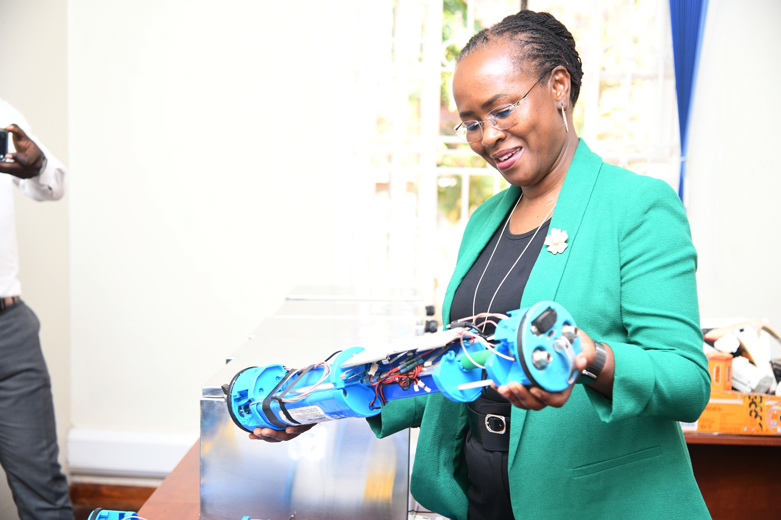 Prof. Sara Ssali inspects the RENUMESH Technologies router. The Deputy Vice Chancellor in charge of Academic Affairs (DVCAA) Prof. Sarah Ssali's guided tour of Research and Education Network for Uganda (RENU)’s Industrial Trainee Program on 15th July 2026, RENU Labs, Edge Road, Makerere University, Kampala Uganda, East Africa.