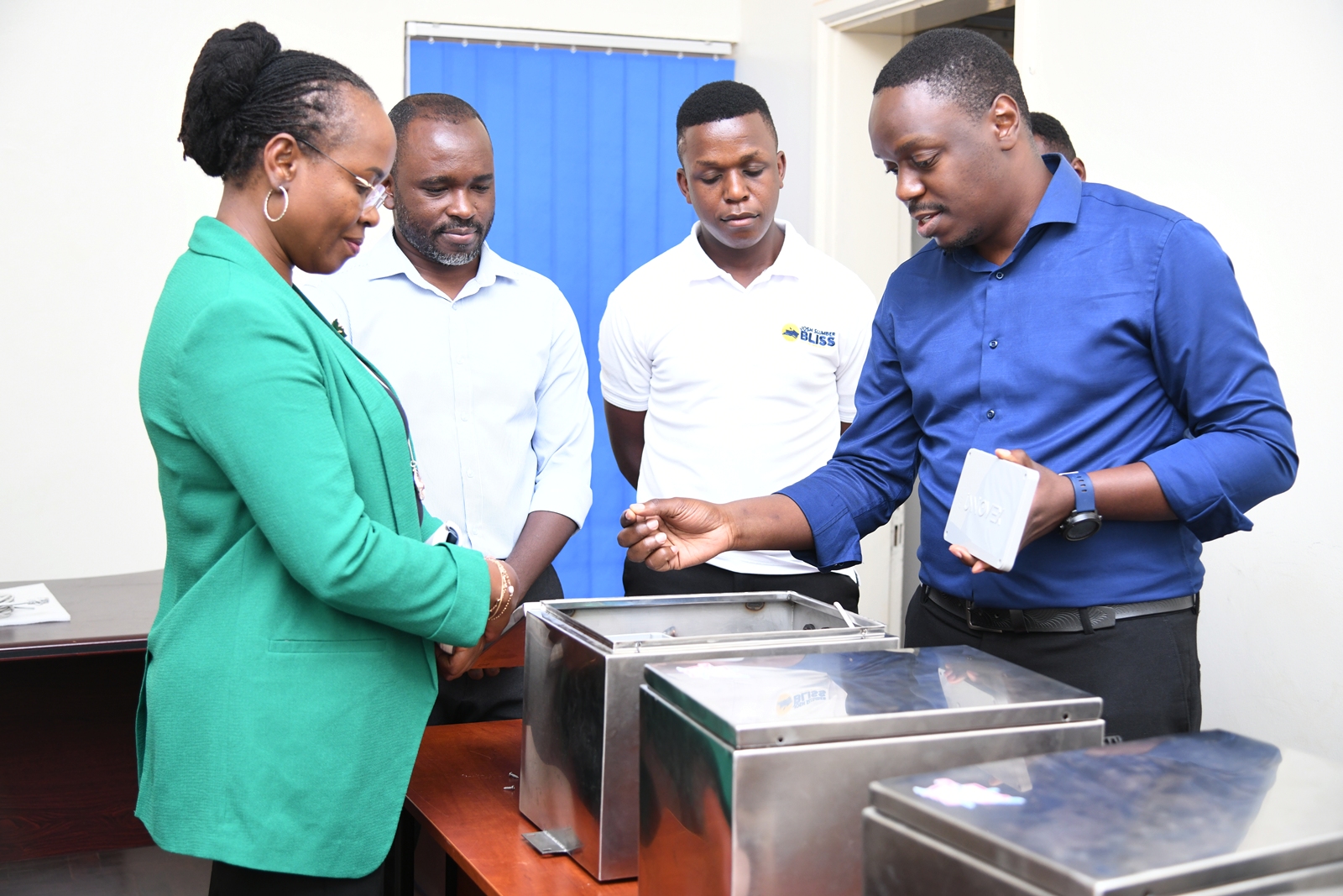 Mr. Brian Masiga (R) walks Prof. Ssali (L) through the layout of the prototype. The Deputy Vice Chancellor in charge of Academic Affairs (DVCAA) Prof. Sarah Ssali's guided tour of Research and Education Network for Uganda (RENU)’s Industrial Trainee Program on 15th July 2026, RENU Labs, Edge Road, Makerere University, Kampala Uganda, East Africa.