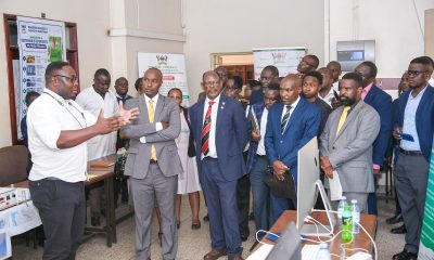 Hon. Eng. Jonard Asiimwe Akiiki (2nd L) with Prof. Barnabas Nawangwe, Prof. Winston Tumps Ireeta, Prof. Robert Wamala and other officials listen to Mr. Eugene Miheso (L) during the stop over at the College of Natural Sciences (CoNAS) on 21st July 2026. Hon. Eng. Jonard Asiimwe Akiiki, Minister of Science, Technology and Innovation in the Office of the President, two-day Ministerial Maiden Visit to Makerere University, 21st-22nd July 2026, Kampala Uganda, East Africa.