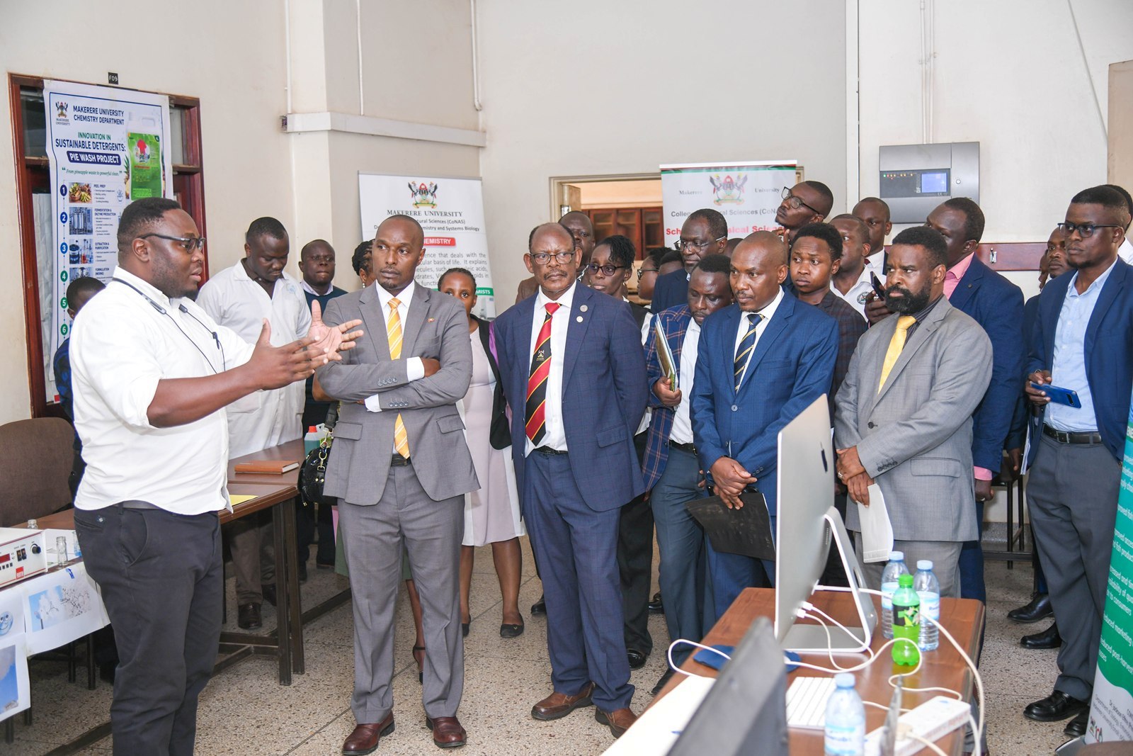 Hon. Eng. Jonard Asiimwe Akiiki (2nd L) with Prof. Barnabas Nawangwe, Prof. Winston Tumps Ireeta, Prof. Robert Wamala and other officials listen to Mr. Eugene Miheso (L) during the stop over at the College of Natural Sciences (CoNAS) on 21st July 2026. Hon. Eng. Jonard Asiimwe Akiiki, Minister of Science, Technology and Innovation in the Office of the President, two-day Ministerial Maiden Visit to Makerere University, 21st-22nd July 2026, Kampala Uganda, East Africa.