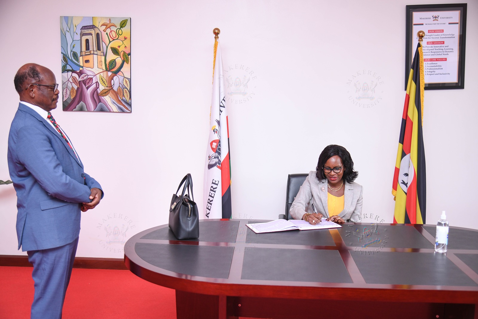 Prof. Pauline Byakika-Kibwika signs the Visitors' Book during her courtesy call on Prof. Barnabas Nawangwe in his office. Vice Chancellor, Prof. Barnabas Nawangwe and Members of Management host delegation from Mbarara University of Science and Technology (MUST) led by the Vice Chancellor Prof. Pauline Byakika-Kibwika to benchmark the Grants Management System, 23rd July 2026, Makerere University, Kampala Uganda, East Africa.