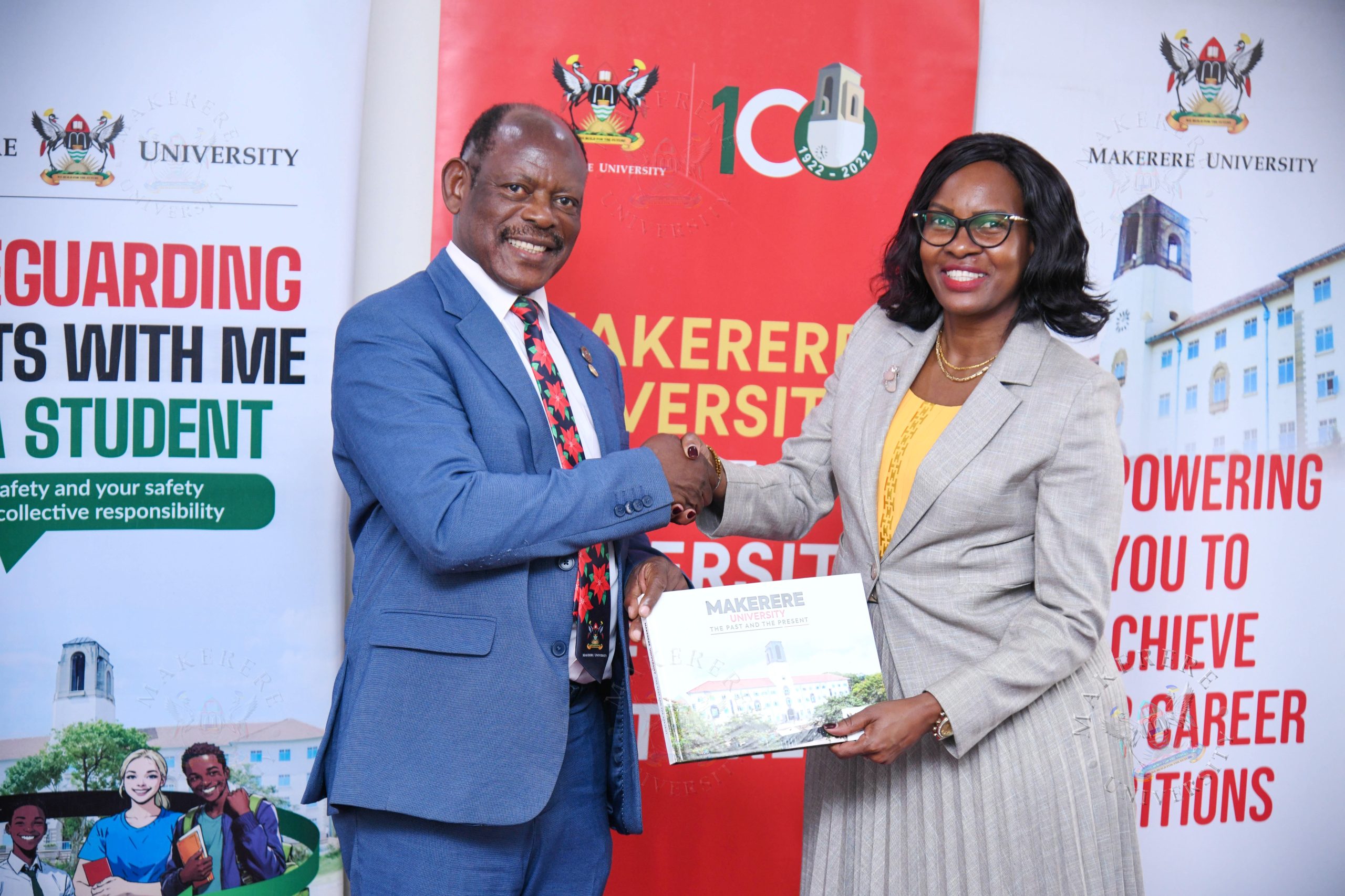 Prof. Barnabas Nawangwe (L) presents the Makerere@100 Coffee Table Book to Prof. Pauline Byakikia-Kibwika (R). Vice Chancellor, Prof. Barnabas Nawangwe and Members of Management host delegation from Mbarara University of Science and Technology (MUST) led by the Vice Chancellor Prof. Pauline Byakika-Kibwika to benchmark the Grants Management System, 23rd July 2026, Makerere University, Kampala Uganda, East Africa.