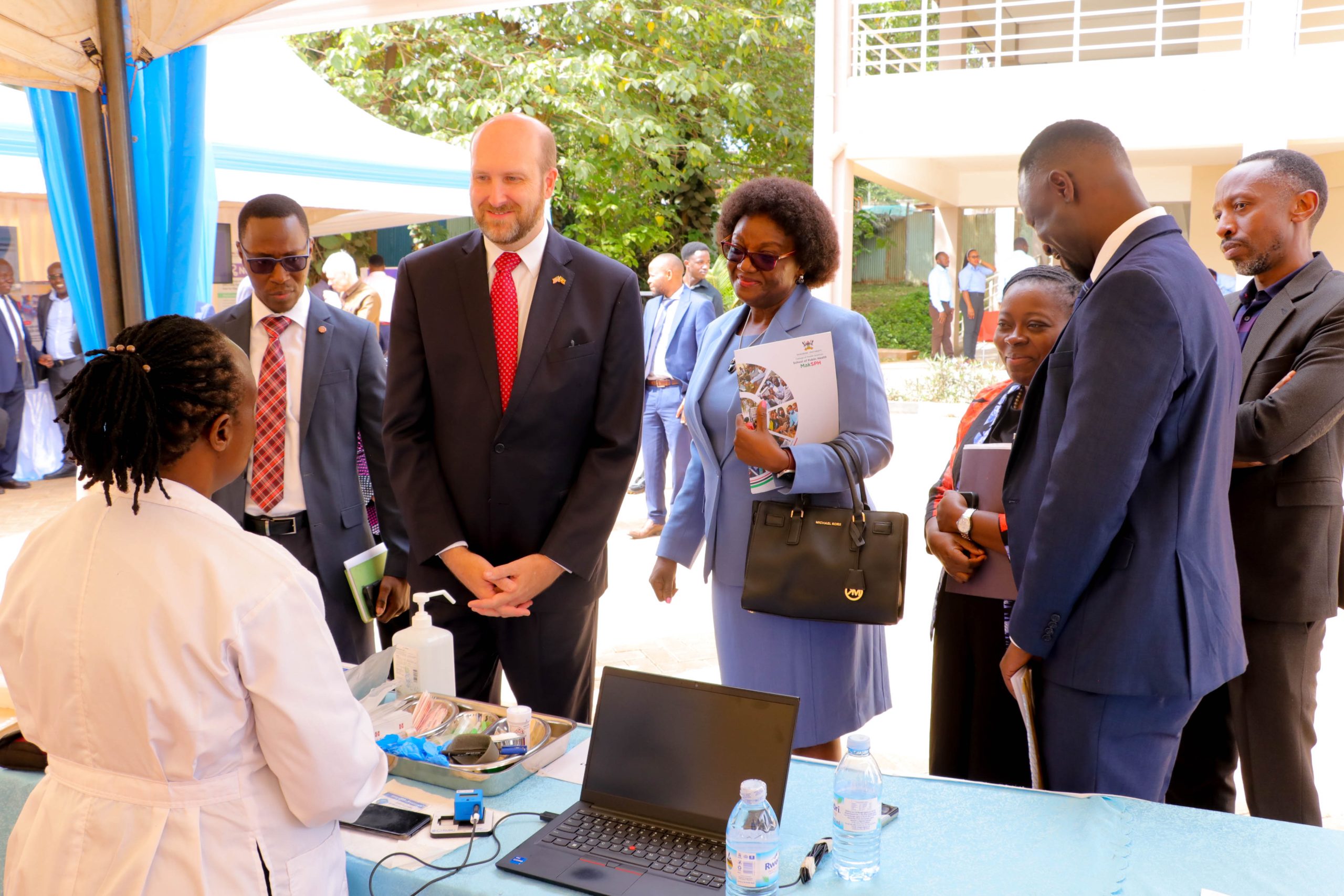 Then U.S. Ambassador to Uganda H.E. William W. Popp tours MakSPH exhibition stands with MakSPH and U.S. CDC leadership during the 2024 dissemination of CRANE Survey results in Kampala. Makerere University School of Public Health (MakSPH) reflection on long and productive partnership with the people and Government of the United States, spanning more than 35 years. Kampala Uganda, East Africa.