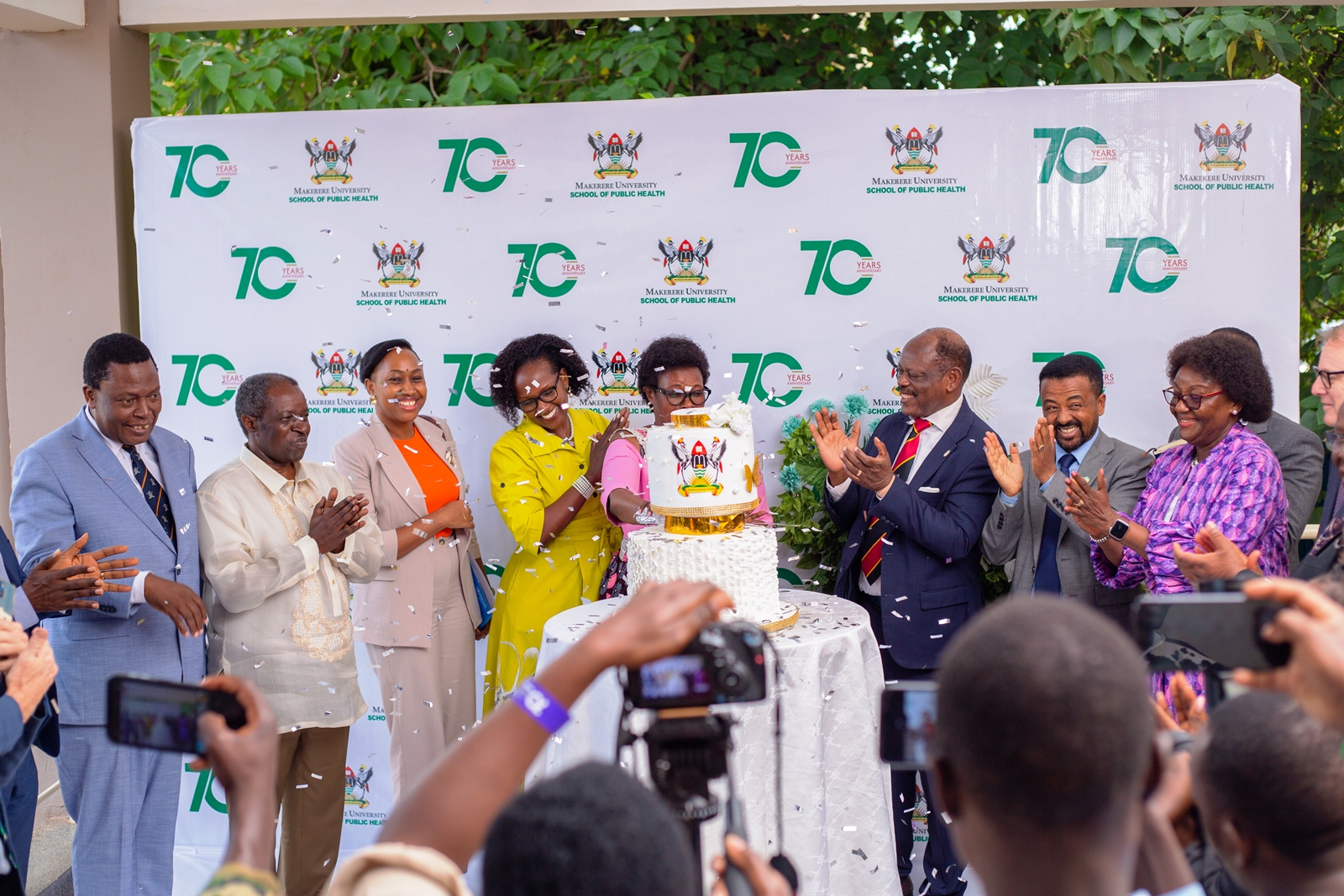 Hon. Margaret Muhanga, then State Minister for Primary Health Care and Chief Guest, joins Makerere University leaders and partners in cutting the MakSPH@70 anniversary cake during the School's 70th anniversary celebrations in December 2024. Makerere University School of Public Health (MakSPH) reflection on long and productive partnership with the people and Government of the United States, spanning more than 35 years. Kampala Uganda, East Africa.
