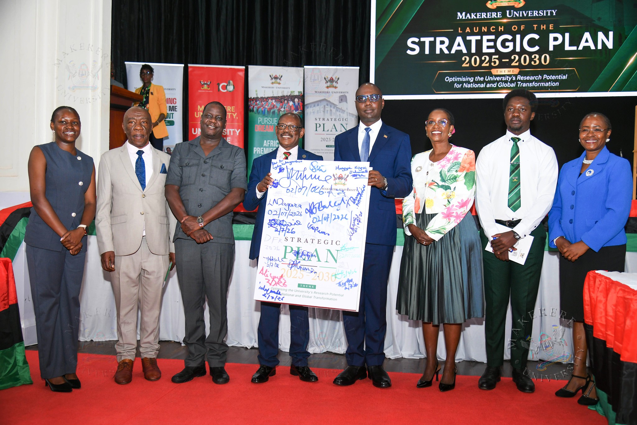 Hon. Henry Musasizi (3rd R) and Prof. Barnabas Nawangwe (2rd L) display an autographed dummy of the signed Strategic Plan as L-R: Hon. Kadondi Gracious, Prof. Henry Alinaitwe, Rt. Hon. Daniel Kidega, Dr. Lorna Magara, H.E. Mubiru John Bosco and Prof. Sarah Ssali witness. Official launch of the Makerere University Strategic Plan 2025-2030 by the Minister of Finance, Planning and Economic Development, Hon. Henry Musasizi, marking a major milestone in its commitment to strengthening research, innovation, and human capital development in line with Uganda’s national development priorities, 2nd July 2026, Main Hall, Kampala Uganda, East Africa.