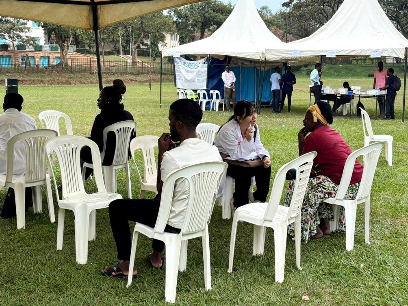 A female medical personnel attends to a female client. The 91st Guild Ministry of Health Annual Makerere Guild Medical Camp, 3rd and 4th October 2025, Freedom Square, Makerere University, Kampala Uganda, East Africa.
