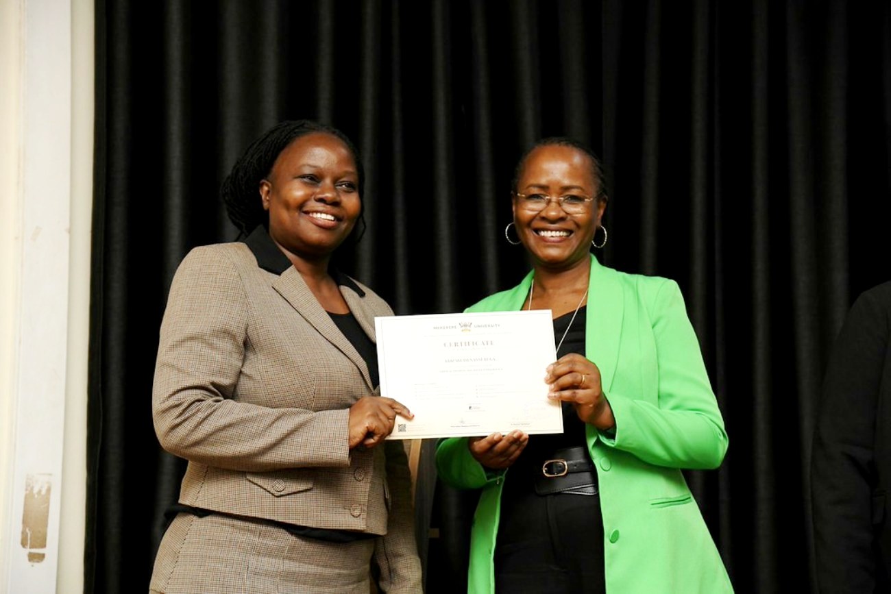 Prof. Sarah Ssali (R) presents a plaque to cohort 1 participant and Staff Member Dr. Elizabeth Nansubuga (L). Award ceremony for the pioneer cohort of the Certificate in Critical Thinking and Social Intelligence, a short course offered by the Department of Philosophy in the School of Liberal and Performing Arts, College of Humanities and Social Sciences (CHUSS) with support from Konrad Adenauer Stiftung and UNESCO. 7th August 2026, Conference Hall, School of Food Technology, Nutrition and Bioengineering, CAES, Makerere University, Kampala Uganda.