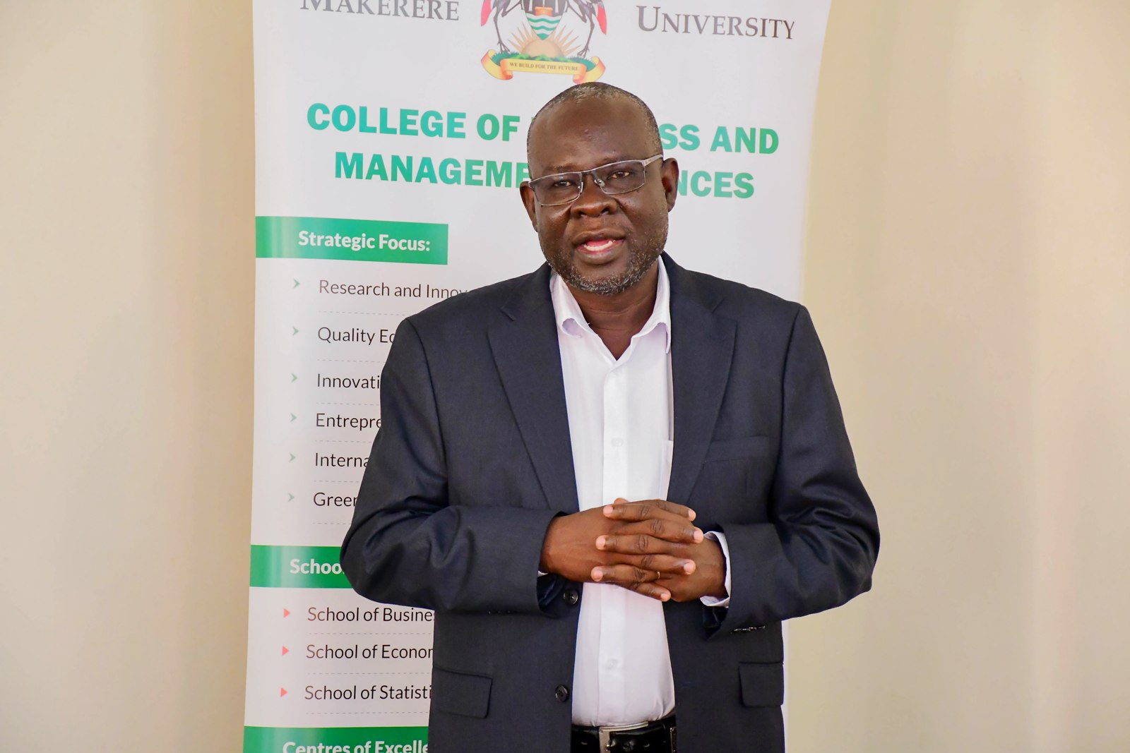 Assoc. Prof. Godfrey Akileng, Dean of the School of Business giving his remarks. Launch of two taught Doctor of Philosophy (PhD) programmes namely: PhD in Management (by coursework) and PhD in Accounting and Finance (by coursework) by School of Business at the College of Business and Management Sciences (CoBAMS), 4th August 2026, Makerere University, Kampala Uganda, East Africa.