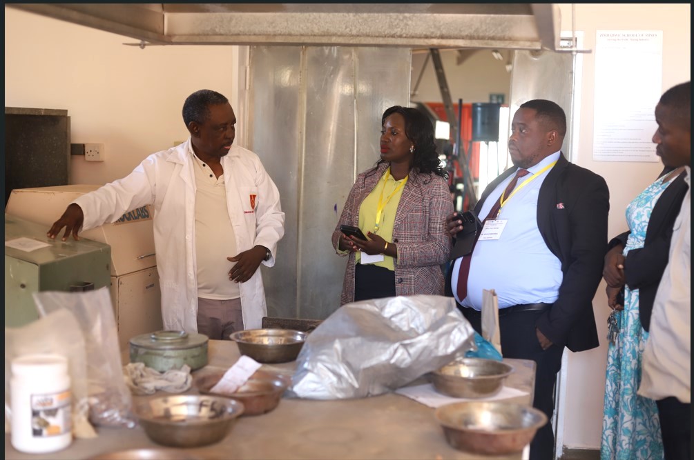 Dr. Joan Nakajigo from the Department of Geology and Petroleum Studies at Makerere University and Mr. Kevin Byamugisha from Uganda’s Ministry of Energy and Mineral Development (centre) touring the Rock pulverising facility at the Zimbabwe School of Mines. Strengthening Uganda’s Mineral Sector through Labour-Market Aligned Curricula Reforms: A Comprehensive Review of BSc/MSc/PhD Geology Curricula and Development of Industry-Aligned Short Courses at Makerere University (Mak-SDMU) Project, Makerere University Department of Geology and Petroleum Studies, Ministry of Energy and Mineral Development (MEMD) benchmarking exercise at Copperbelt University (CBU) in Kitwe, Zambia, and the Zimbabwe School of Mines (ZSM), 19th-23rd July 2026.