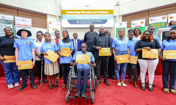 A cross-section of Cohort 9 Scholars pose in a photo with officials shortly after getting their award letters. Award Ceremony for Cohort 9 of 258 recipients of the prestigious Mastercard Foundation scholarship for the 2026/2027 academic, 20th August 2026, Makerere University School of Public Health (MakSPH) Auditorium, Main Campus, Kampala Uganda, East Africa.