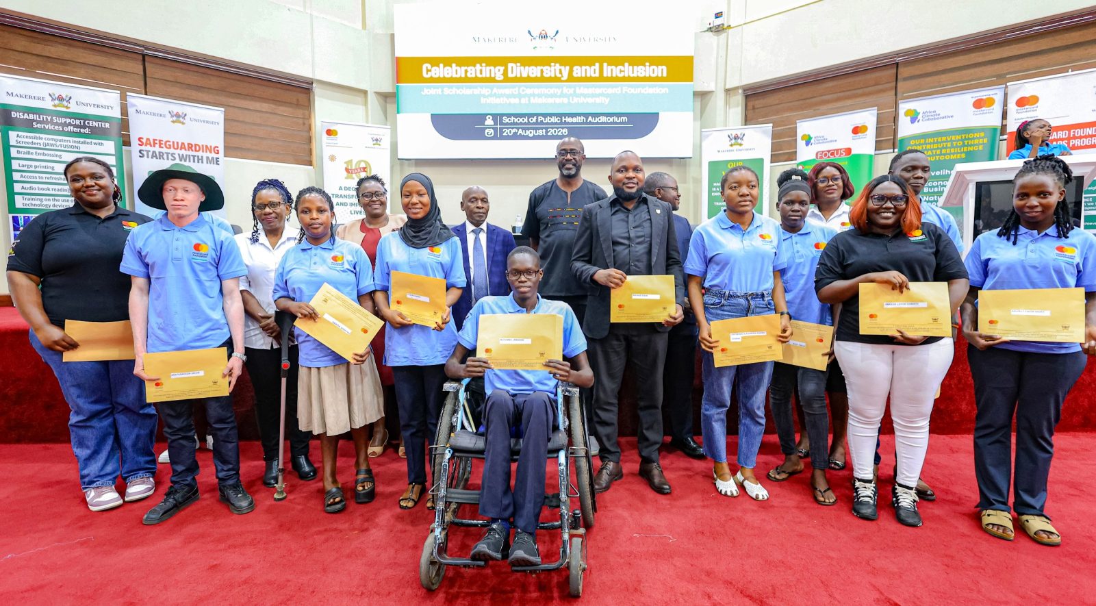 A cross-section of Cohort 9 Scholars pose in a photo with officials shortly after getting their award letters. Award Ceremony for Cohort 9 of 258 recipients of the prestigious Mastercard Foundation scholarship for the 2026/2027 academic, 20th August 2026, Makerere University School of Public Health (MakSPH) Auditorium, Main Campus, Kampala Uganda, East Africa.