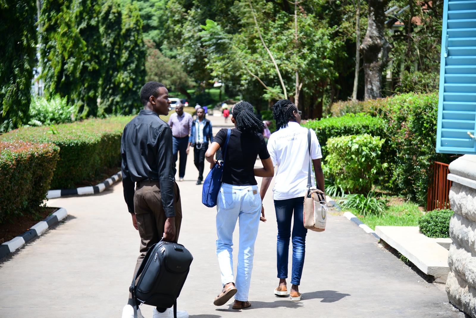 Female and male students along the Main Building Walkway on a bright sunny day, 6th May 2026. Makerere University, Kampala Uganda, East Africa.