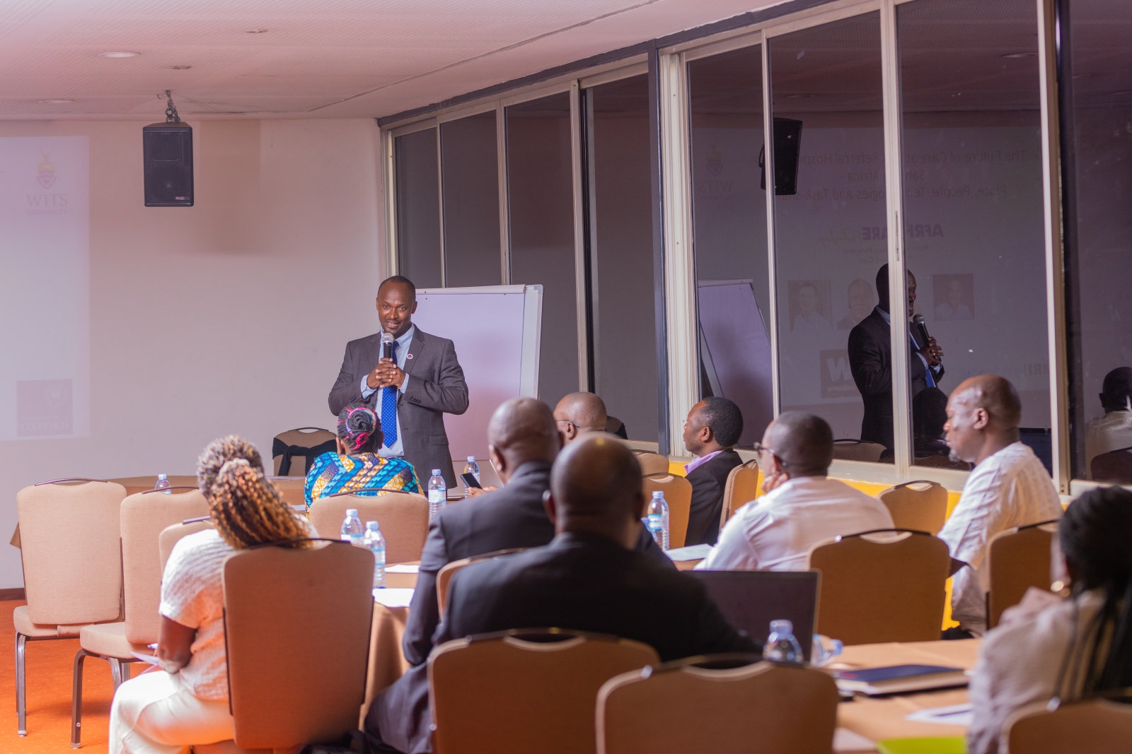 Dr. Raymond Tweheyo makes his presentation. Makerere University School of Public Health (MakSPH) Wellcome Trust through a 2023–2029 Discovery Award-funded Future of Africa’s First Referral Hospitals: Innovation and Care (AFRHiCARE) research initiative stakeholders from five first-referral hospitals in Uganda meeting to review research findings, reflect on persistent challenges and identify practical solutions to strengthen hospital performance and quality of care, 13th August 2026, Kabira Country Club, Kampala Uganda, East Africa.