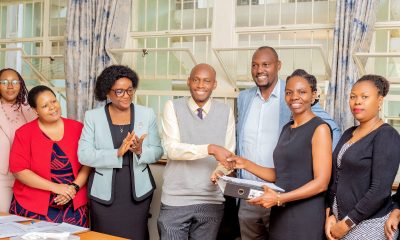 Officials witness as Dr. David Musoke and Dr. Esther Buregyeya shake hands at the handover ceremony on 11th August 2026. Makerere University School of Public Health (MakSPH) leadership transition, Department of Disease Control and Environmental Health, Dr. David Musoke takes over from Dr. Esther Buregyeya, 11th August 2026, Mulago Hospital Complex, Kampala Uganda, East Africa.