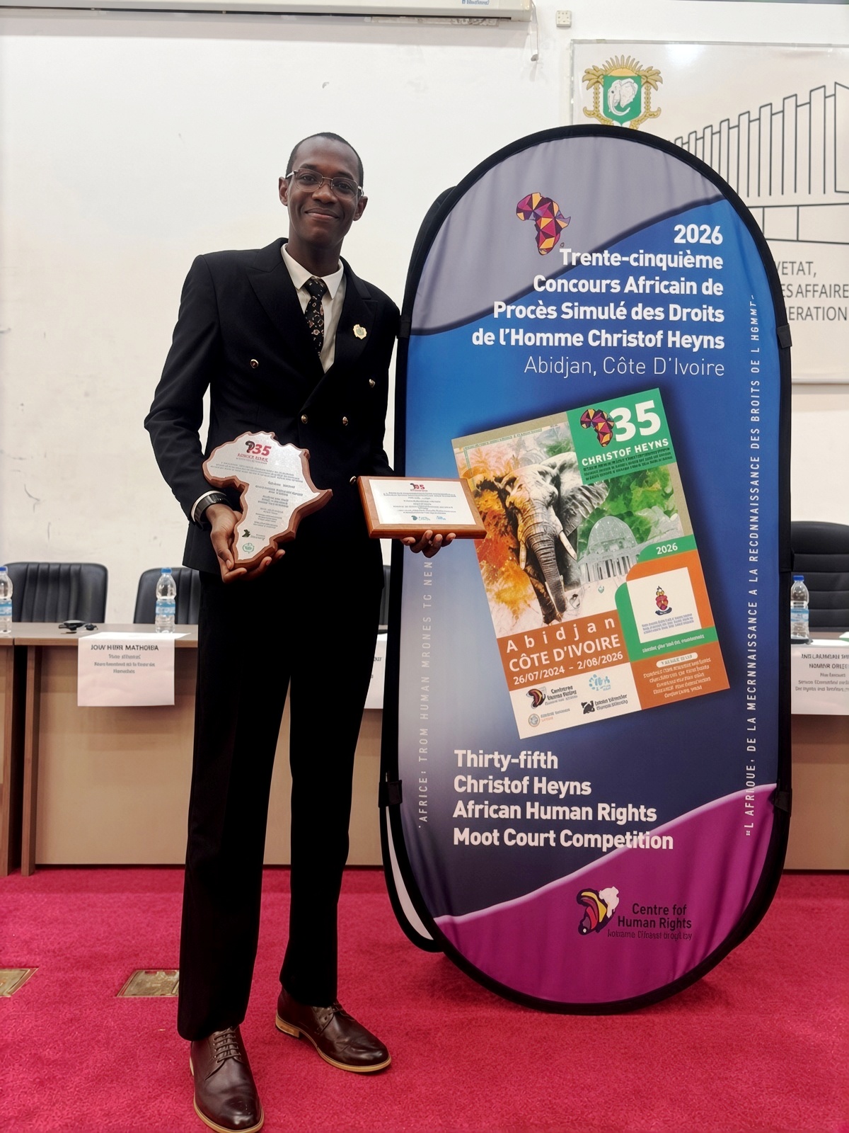 Conrad Akesigaruhanga with his trophies. Makerere University School of Law (SoL) 1st Runners-Up in the week-long (26 July to 2 August 2026) 35th Christof Heyns All Africa Human Rights Moot Court Competition, Institut Universitaire d’Abidjan in Abidjan, Côte d’Ivoire, West Africa.