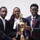 L-R: SoL team, Rodrick Kakwezi, Olga Asianut Blessing with colleague holding the trophy. Inaugural Digital Health Inter-University Moot Court Competition Held in partnership with the University of Warwick and supported by the Wellcome Trust, 12–13 August 2026, School of Law (SoL), Makerere University, Kampala Uganda, East Africa.