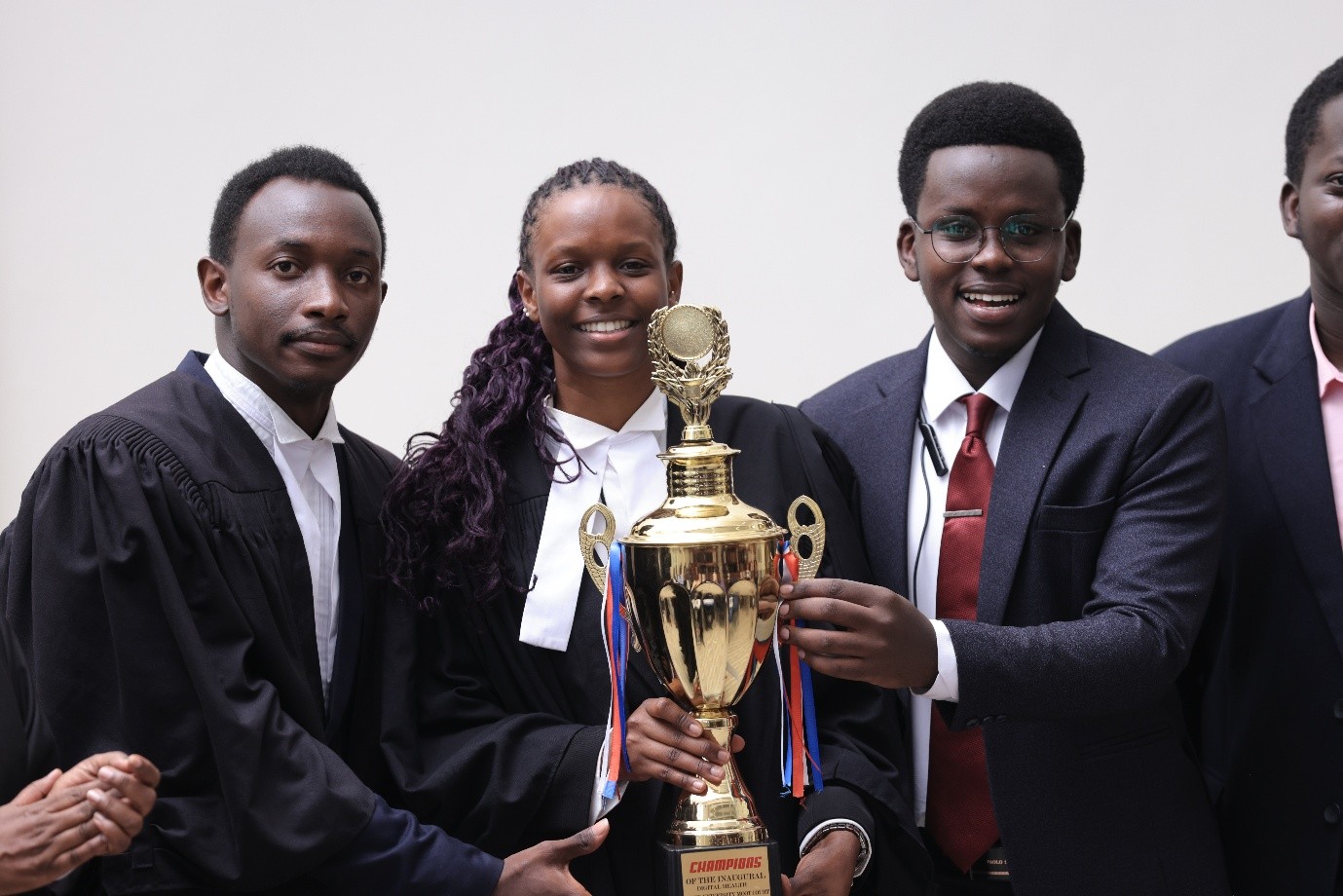 L-R: SoL team, Rodrick Kakwezi, Olga Asianut Blessing with colleague holding the trophy. Inaugural Digital Health Inter-University Moot Court Competition Held in partnership with the University of Warwick and supported by the Wellcome Trust, 12–13 August 2026, School of Law (SoL), Makerere University, Kampala Uganda, East Africa.
